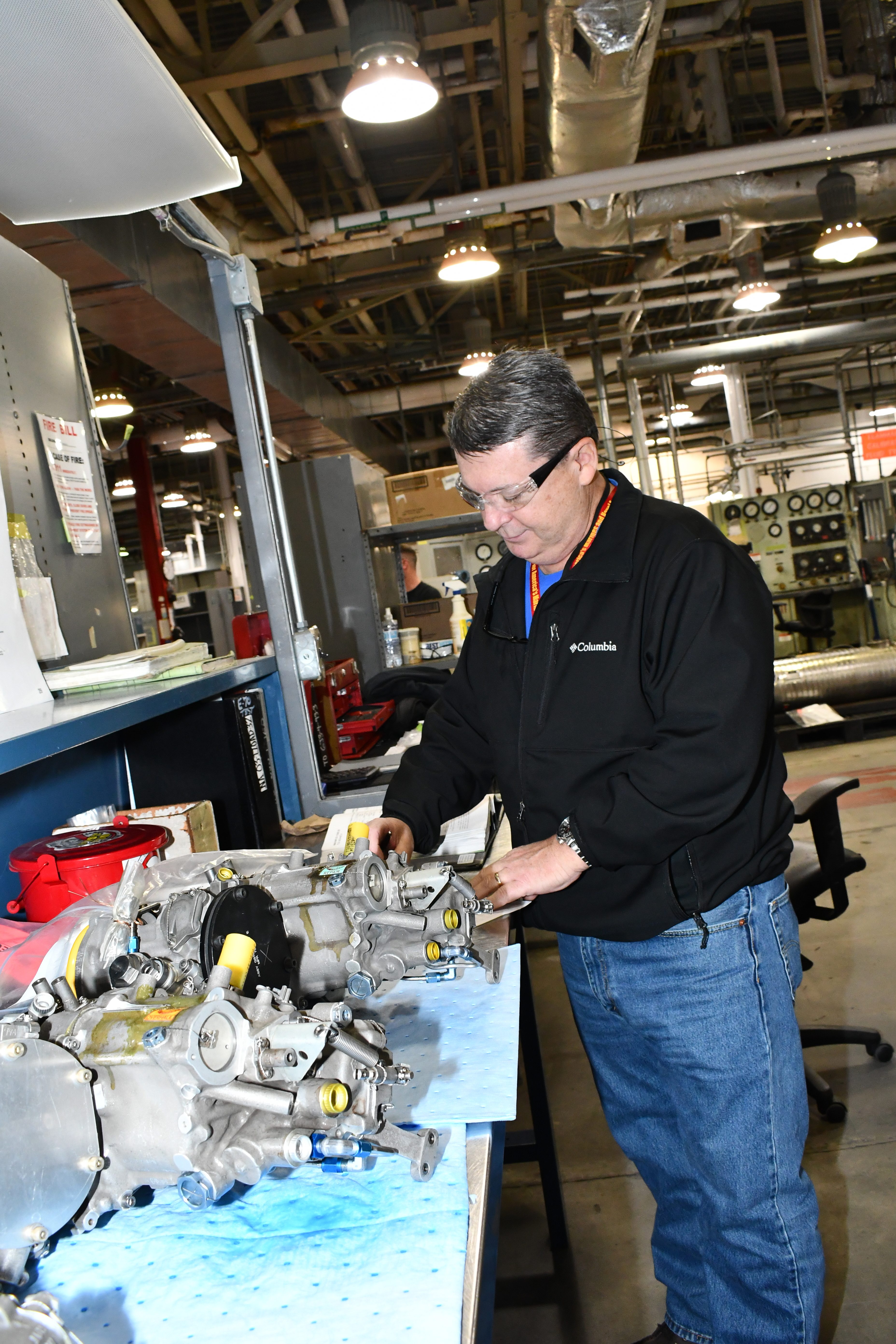 Quality assurance specialist examines completed fuel control unit