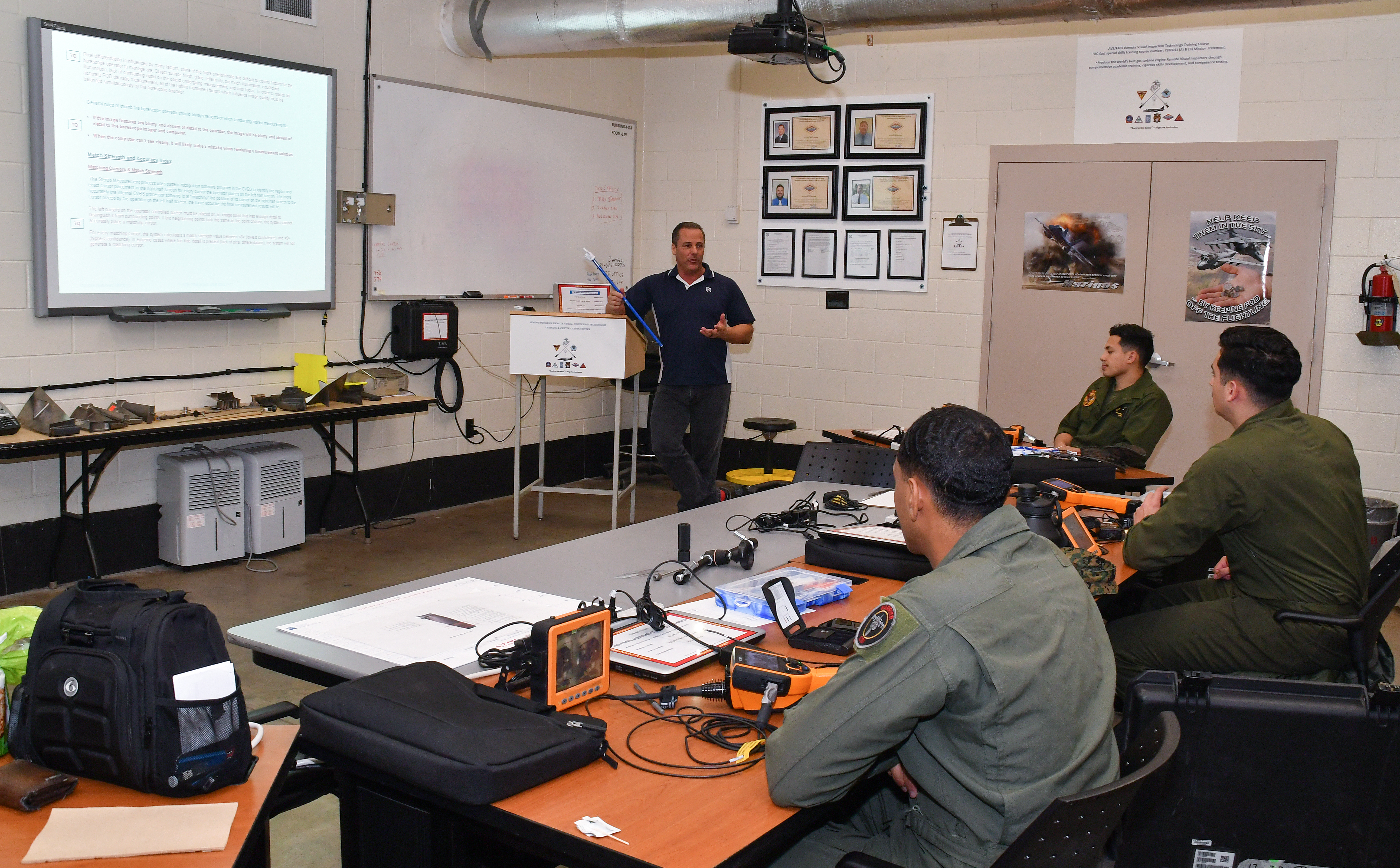 U.S. Marines assigned to Marine Attack Squadron (VMA) 223 engage in classroom discussion during the F402 Engine Tier 5 Remote Visual Inspection (RVI) Inspector Rating certification course at Fleet Readiness Center East, Mar. 6, 2023. 