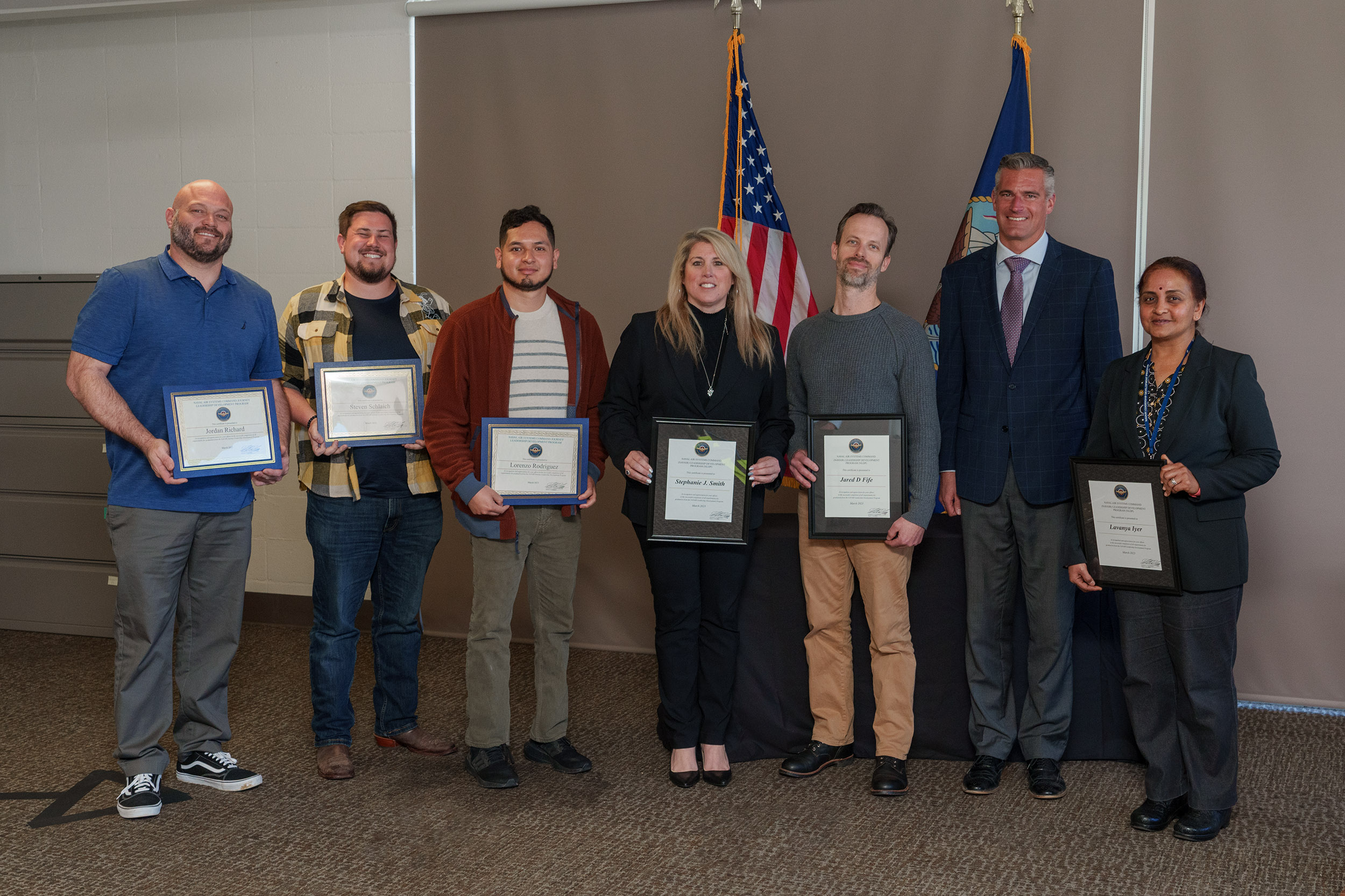 NAWCWD graduates for NLDP and JLDP who attended graduation at Point Mugu pose with Pat Schuett, NAWCWD product director for Air Wing Integration & Interoperability/EW Effects, second right, on March 29. (U.S. Navy Photo by Rob Grabendike)