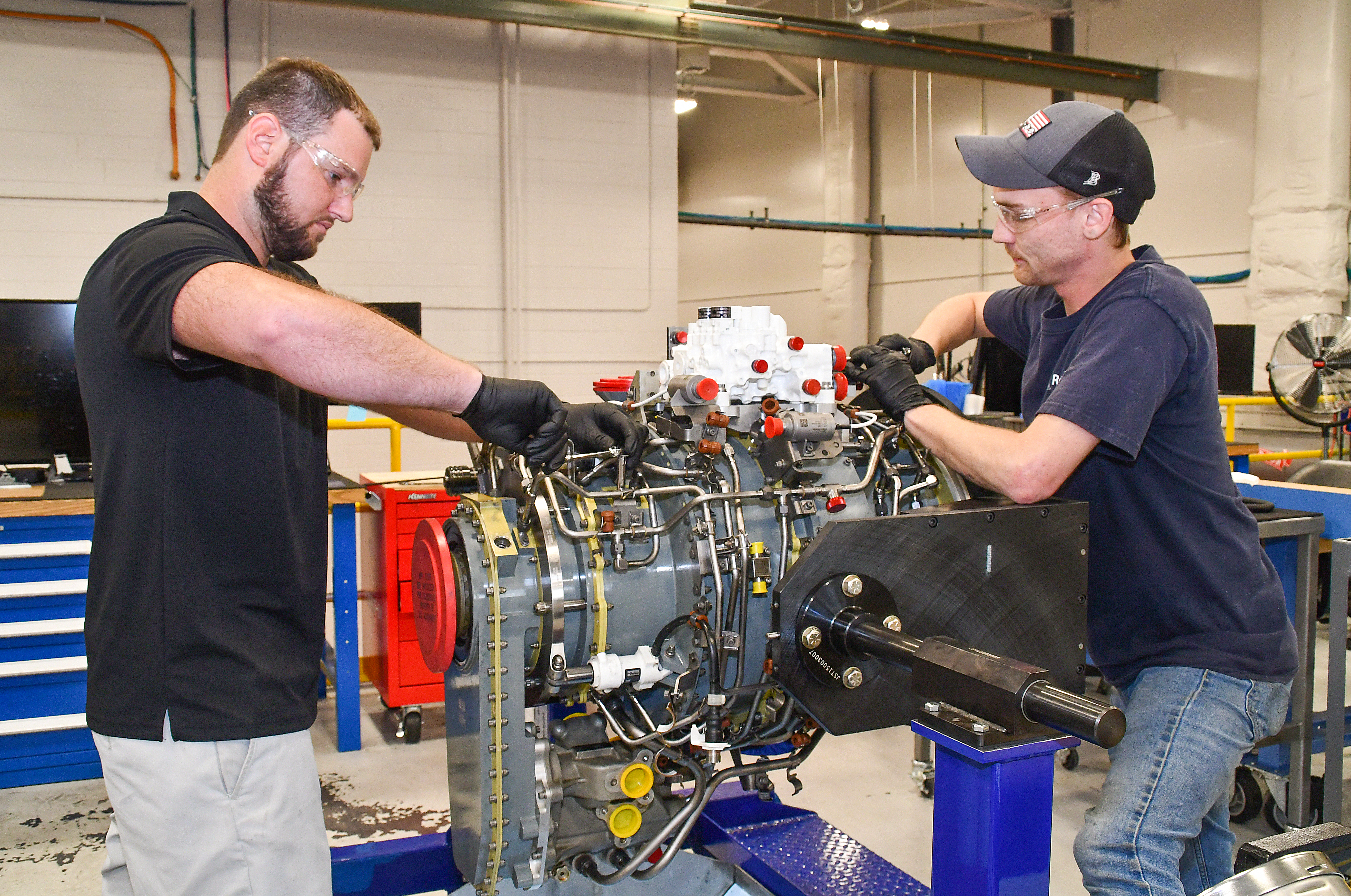 Steven Murray, left, and Dakota Martin, aircraft engine mechanics at Fleet Readiness Center East (FRCE, begin disassembly of a lift fan clutch for the F-35B Lightning II aircraft. FRCE personnel became the first within the Department of Defense (DoD) to perform a successful assembly of this component outside of Rolls Royce’s LiftWorks facility in Indianapolis. 