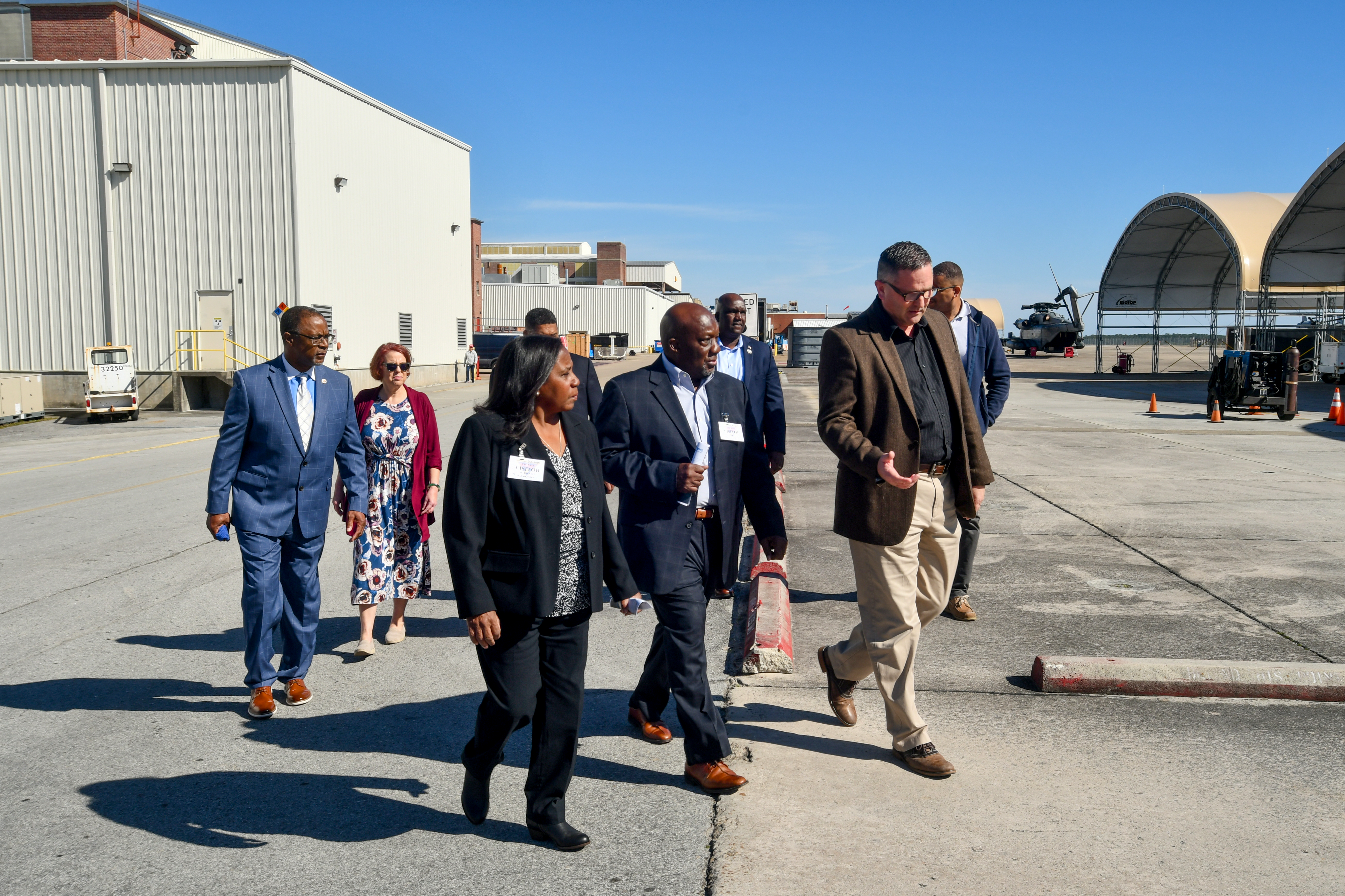 Eight individuals walking outside 