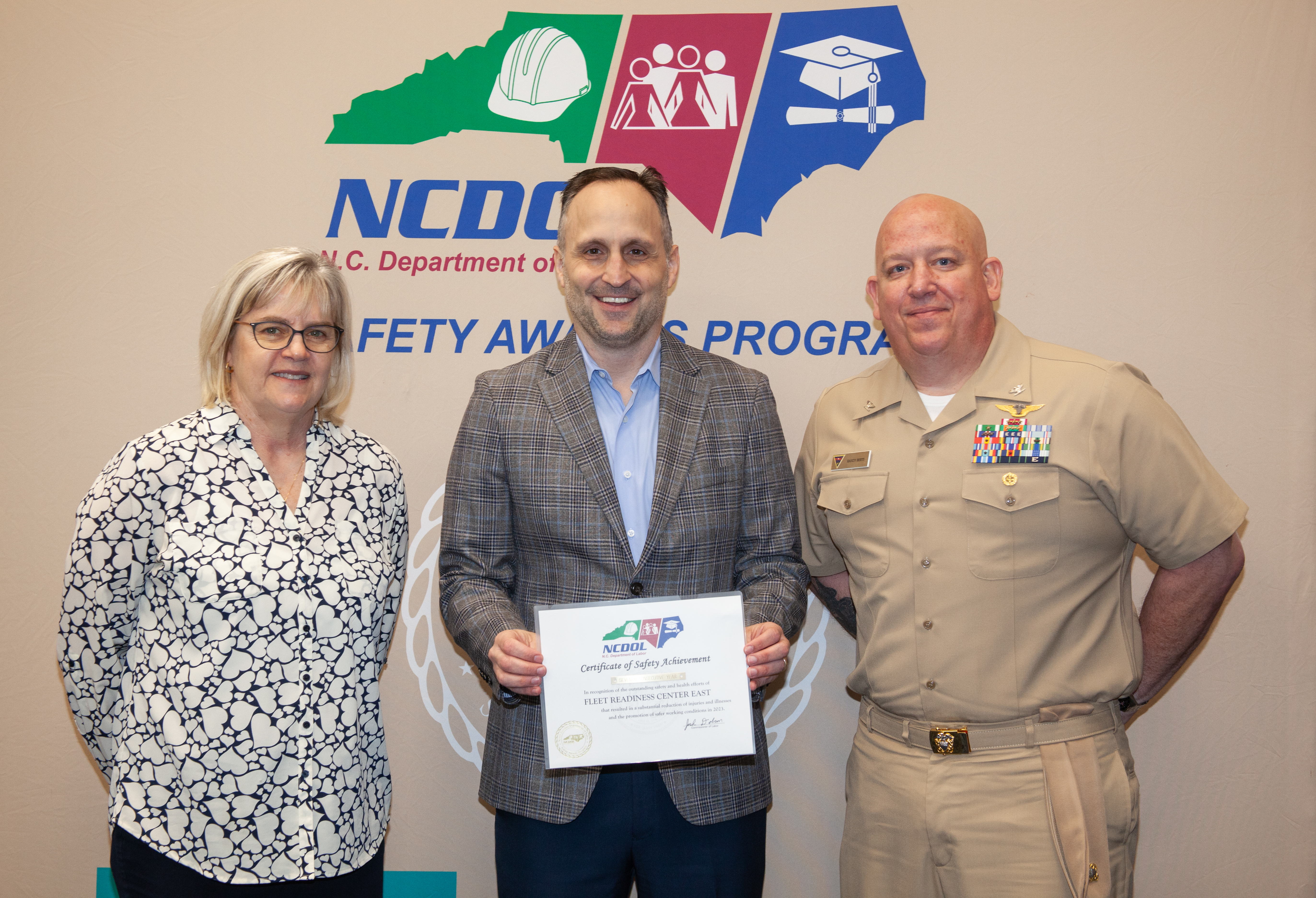 Fleet Readiness Center East Executive Officer and Compliance and Quality Department Head pose for group photo with North Carolina Labor Commissioner