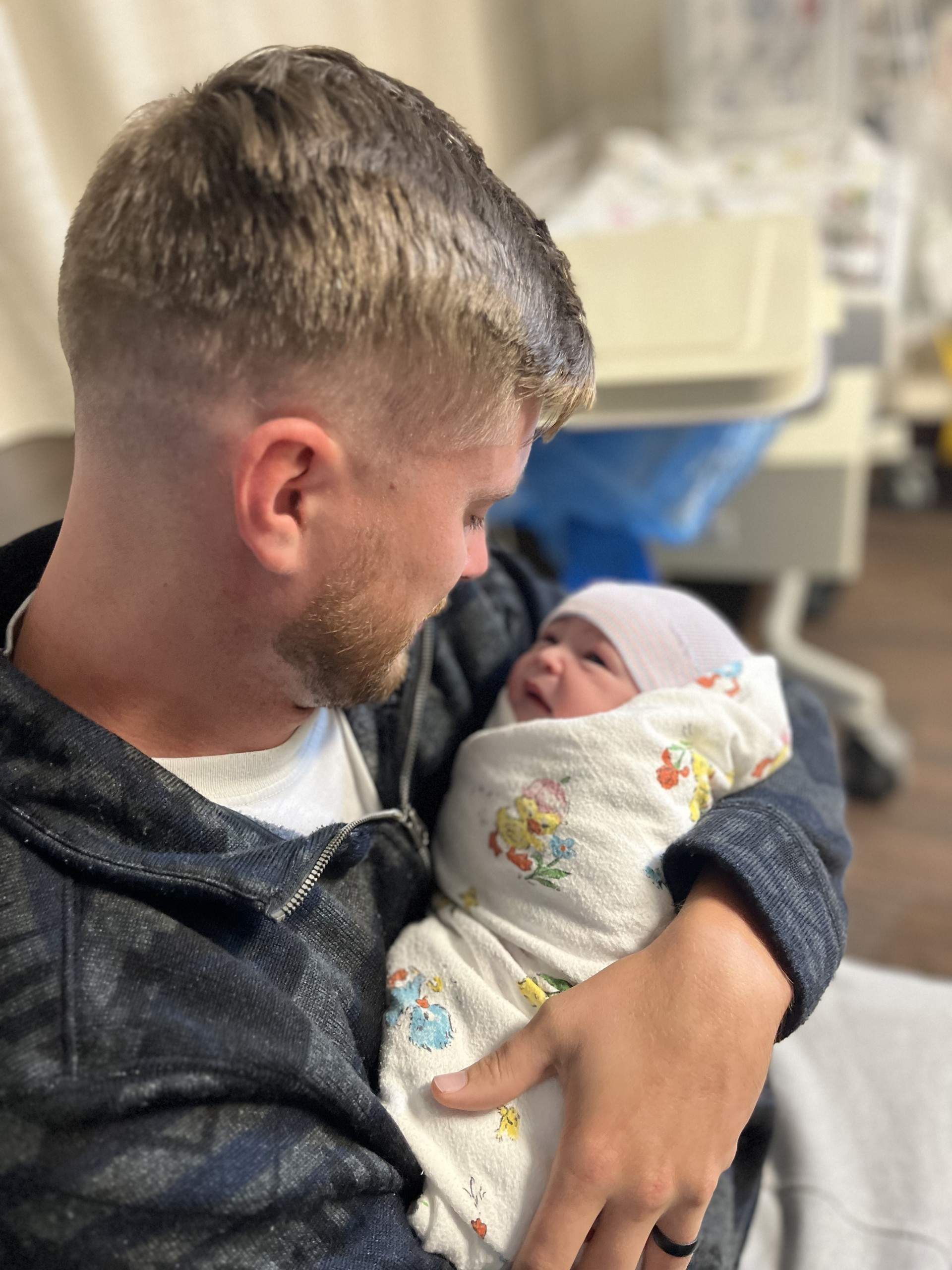 Man holding a newborn baby 