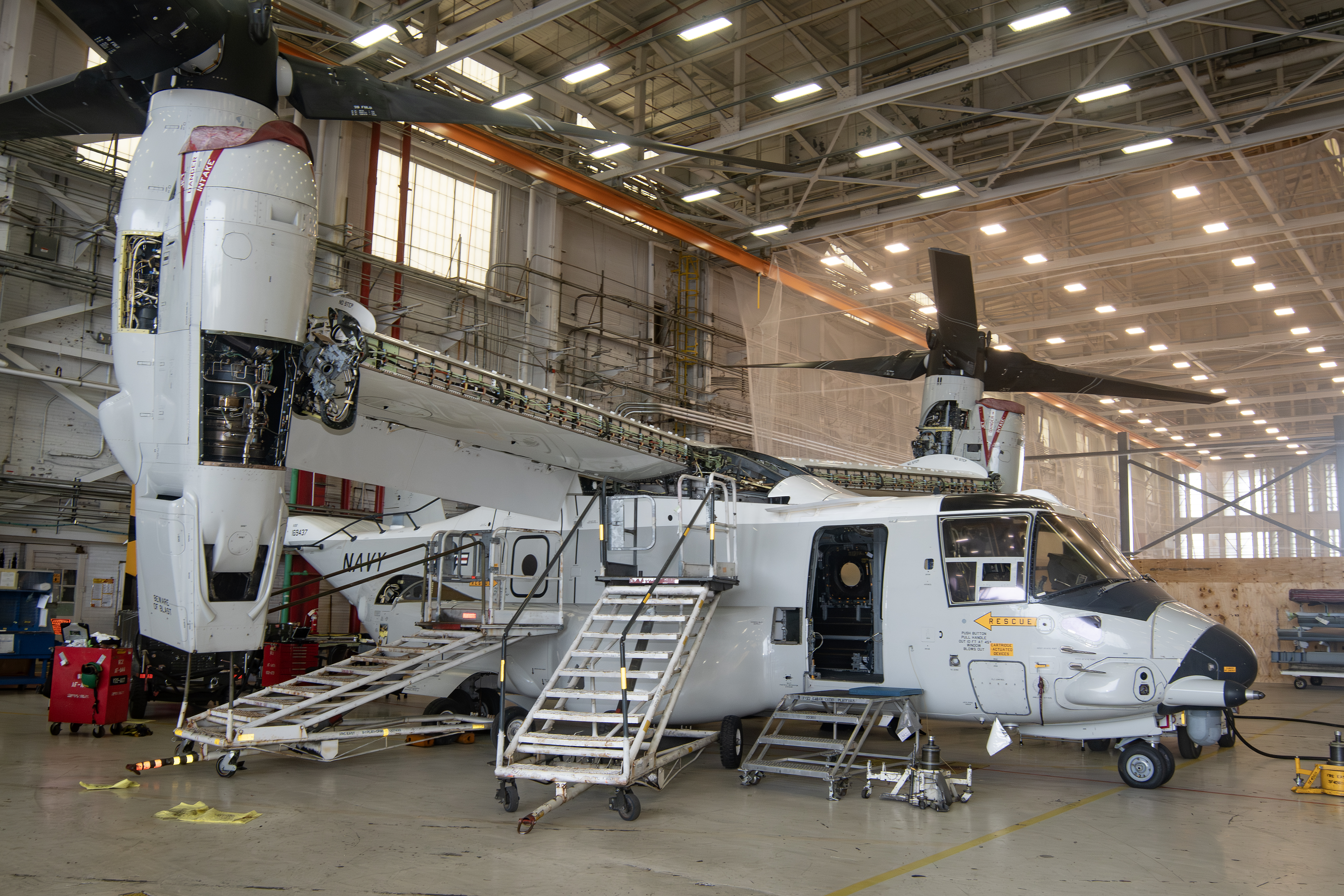 Navy CMV-22B aircraft in maintenance hangar