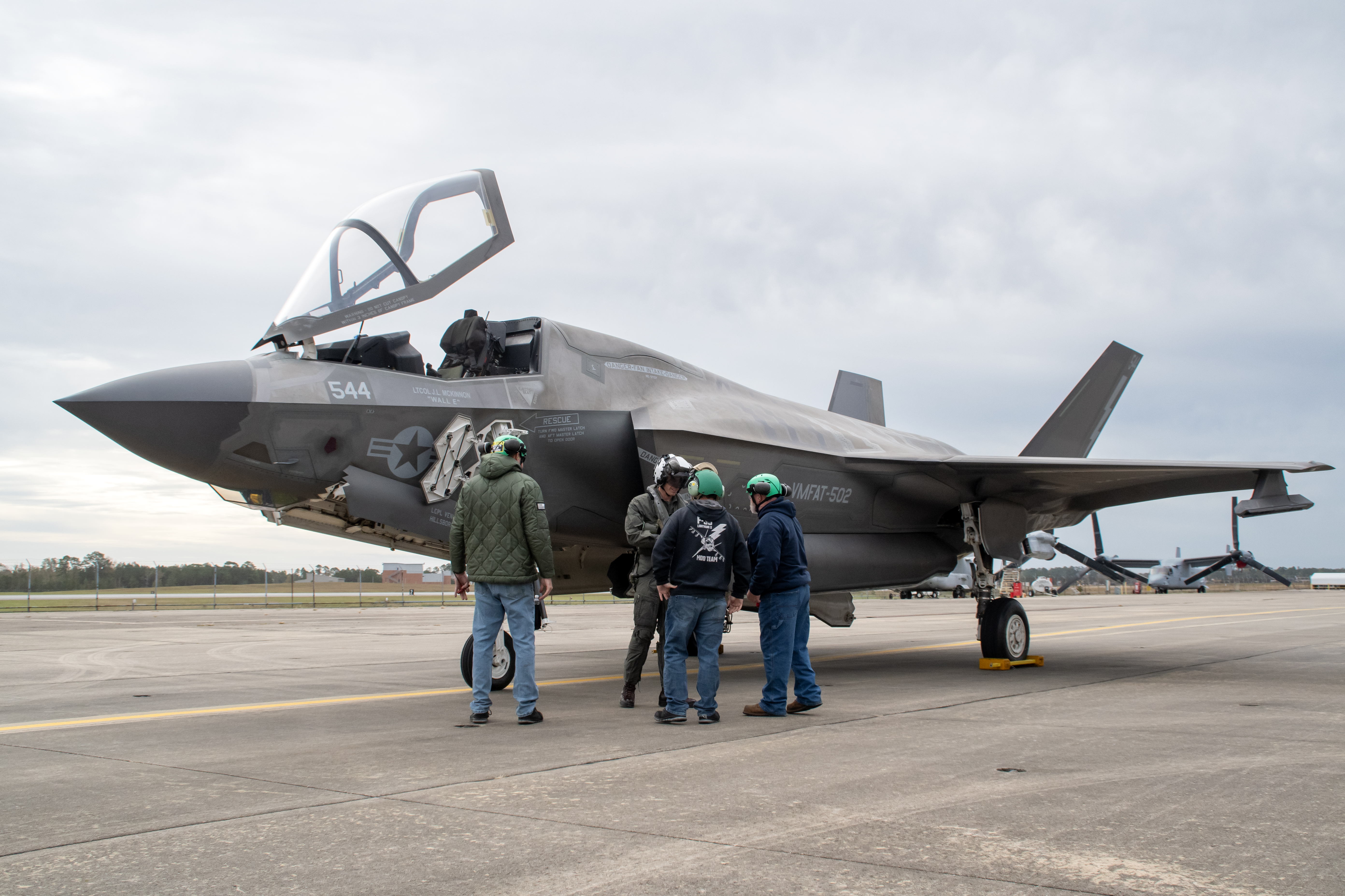 Workers on the Fleet Readiness Center East (FRCE) F-35 Lightning II aircraft modification line confer with the pilot prior to conducting a functional check flight inspection on an F-35B at Marine Corps Air Station Cherry Point. 