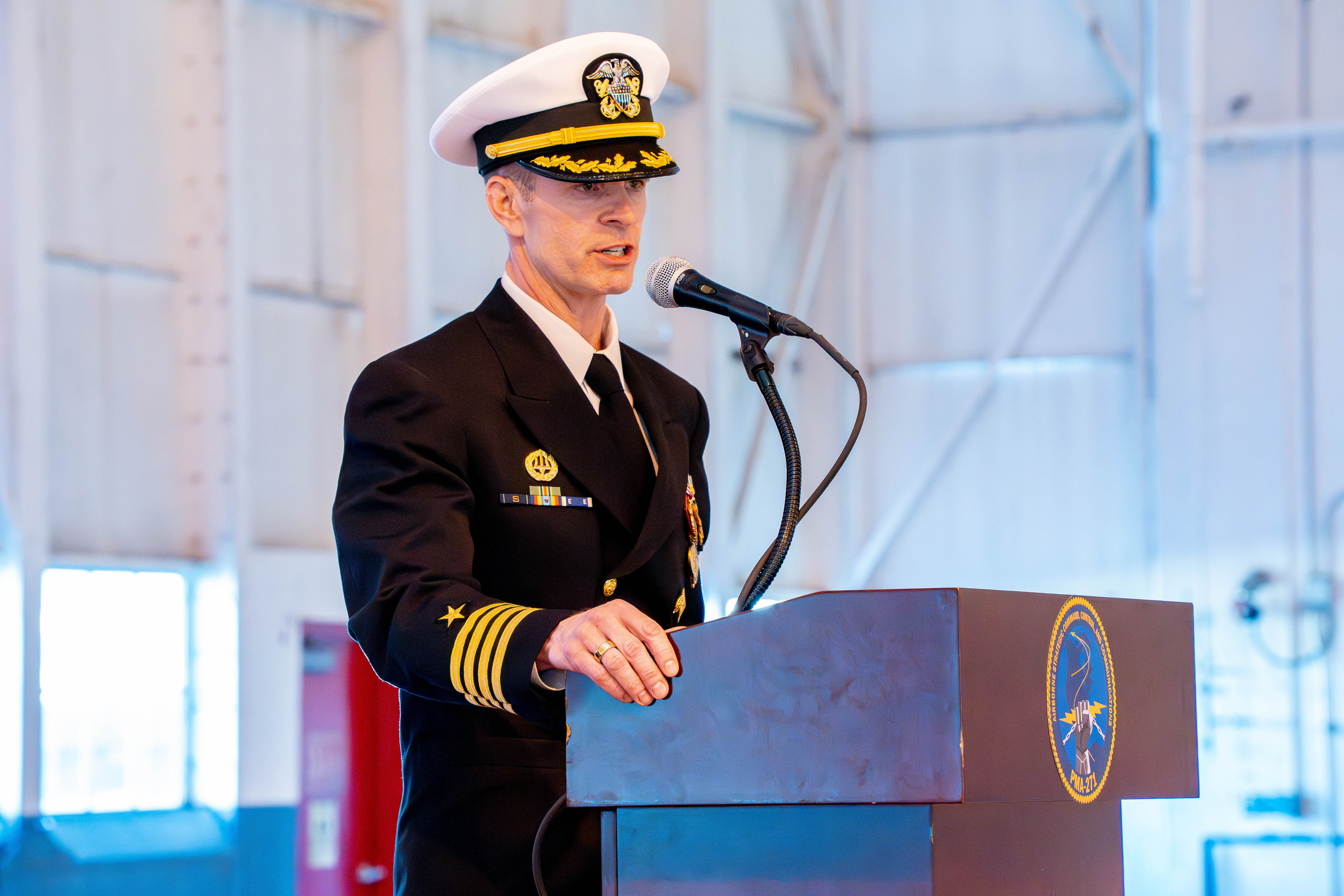 Sailor speaking at a podium