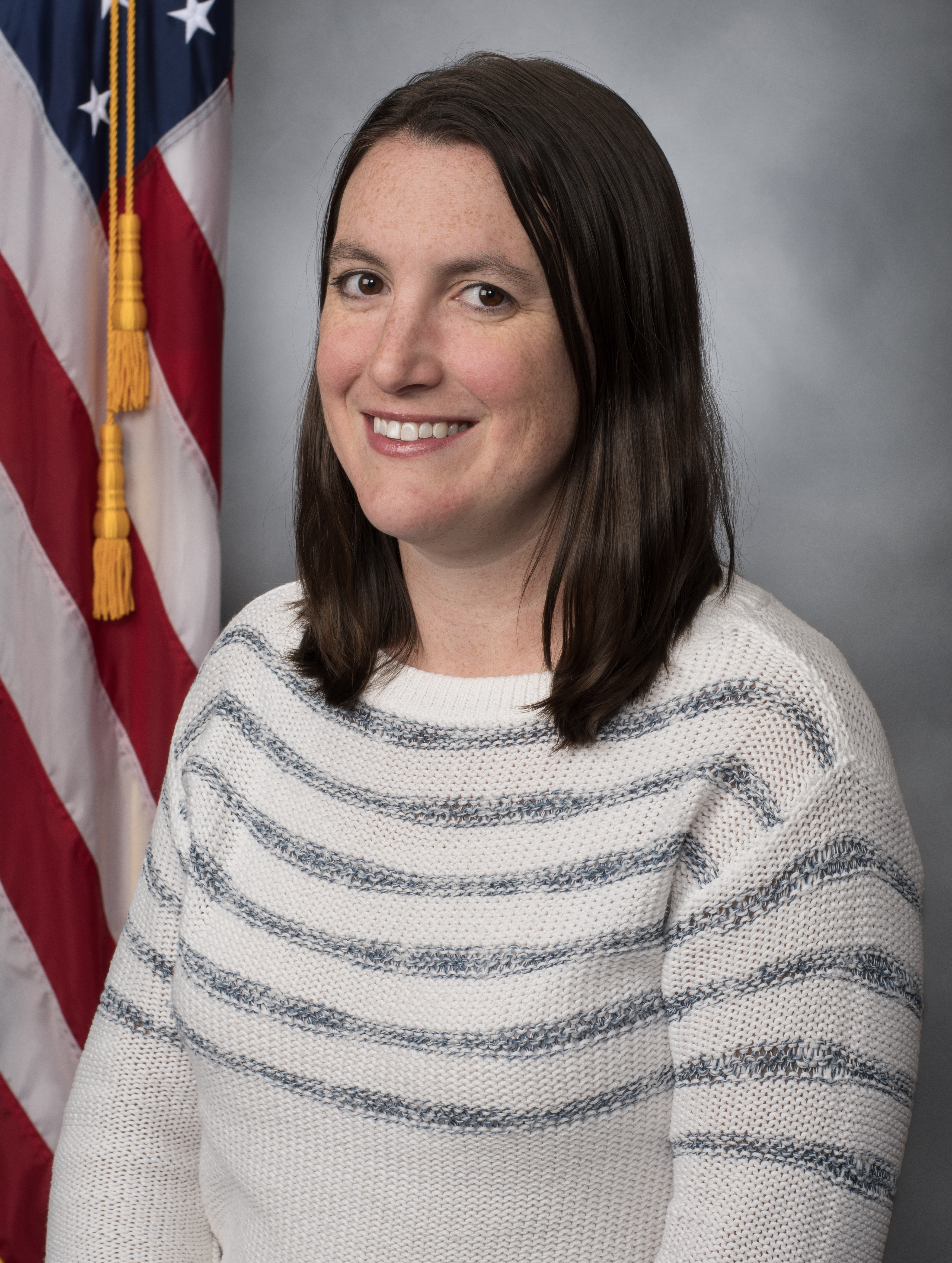 Portrait of female in front of American flag 