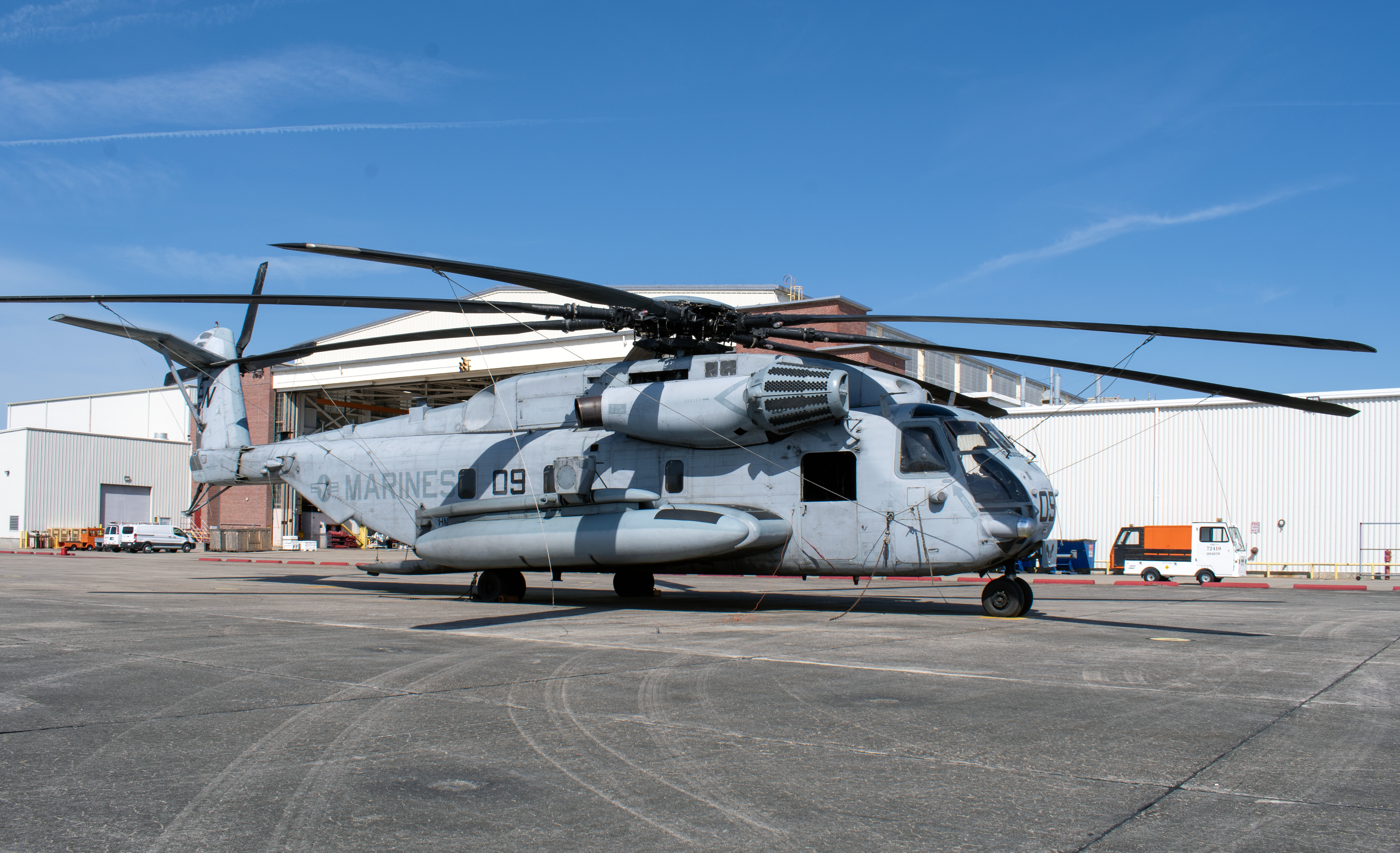 H-53 helicopter outside in front of an aircraft hangar
