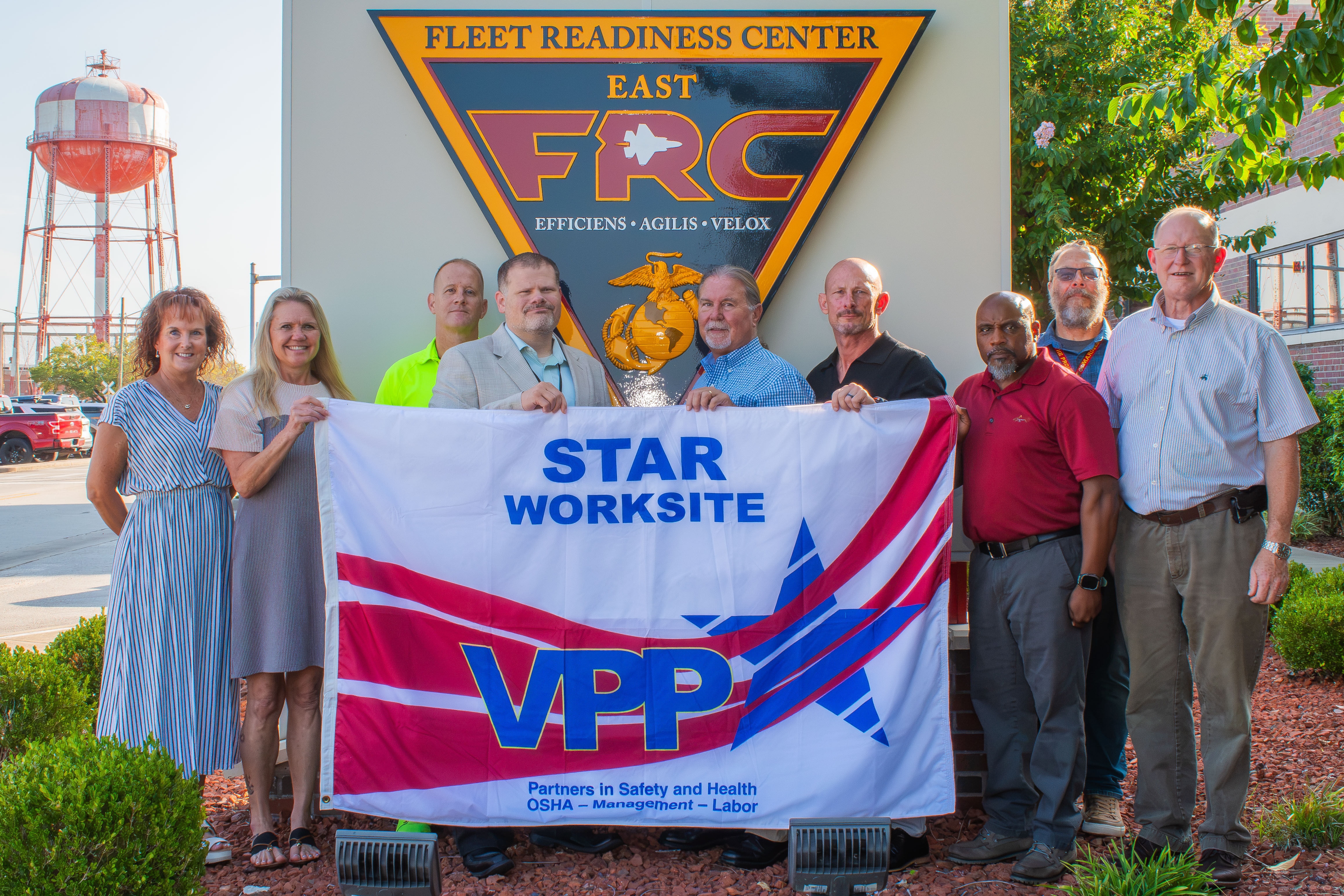  FRCE safety leaders stand with the new VPP flag.