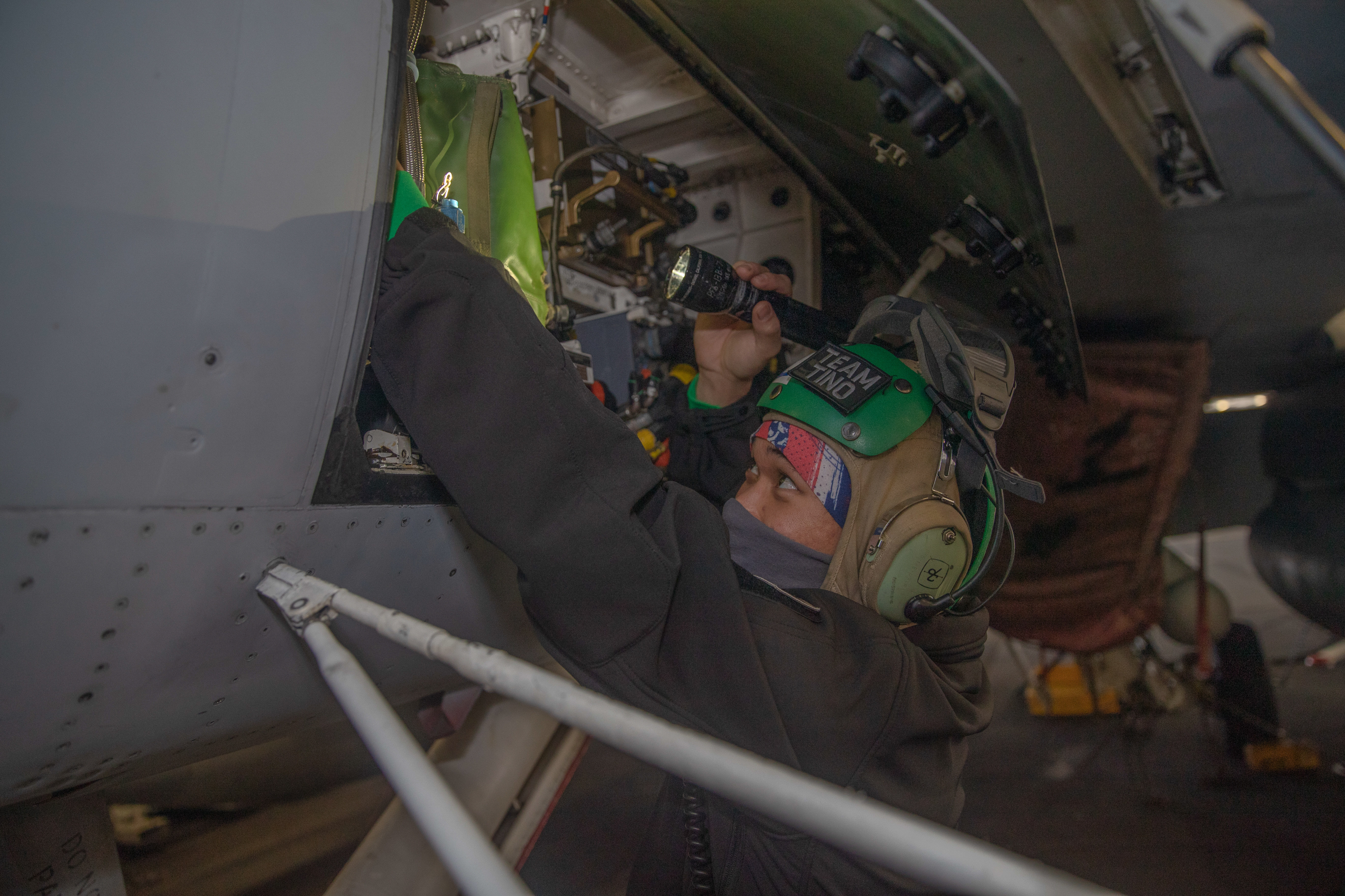 Maintenance on an F/A-18E Super Hornet in USS Gerald R. Ford's (CVN 78) hangar bay