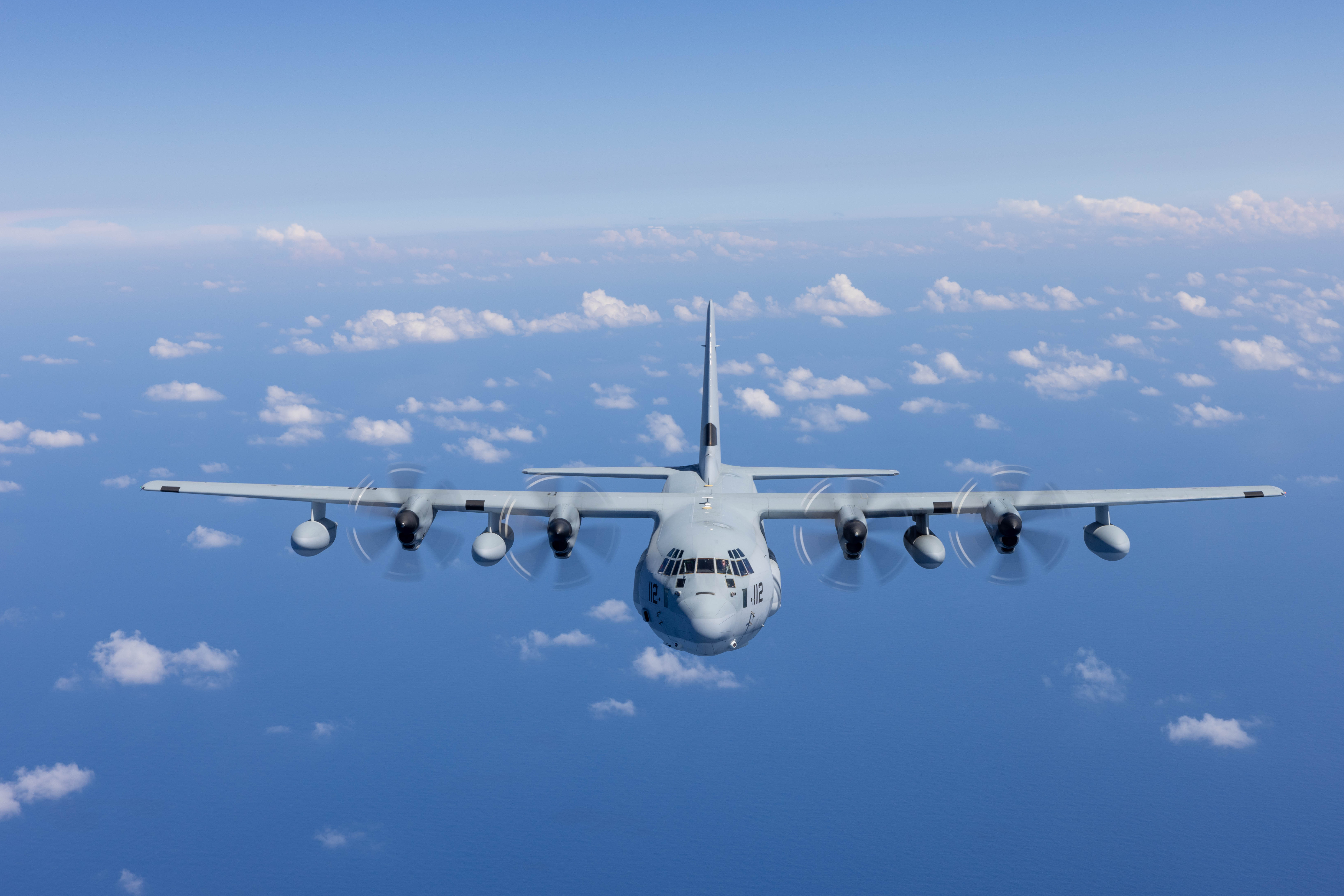 KC-130J Super Hercules Airplane Flying in a Blue Sky with Clouds