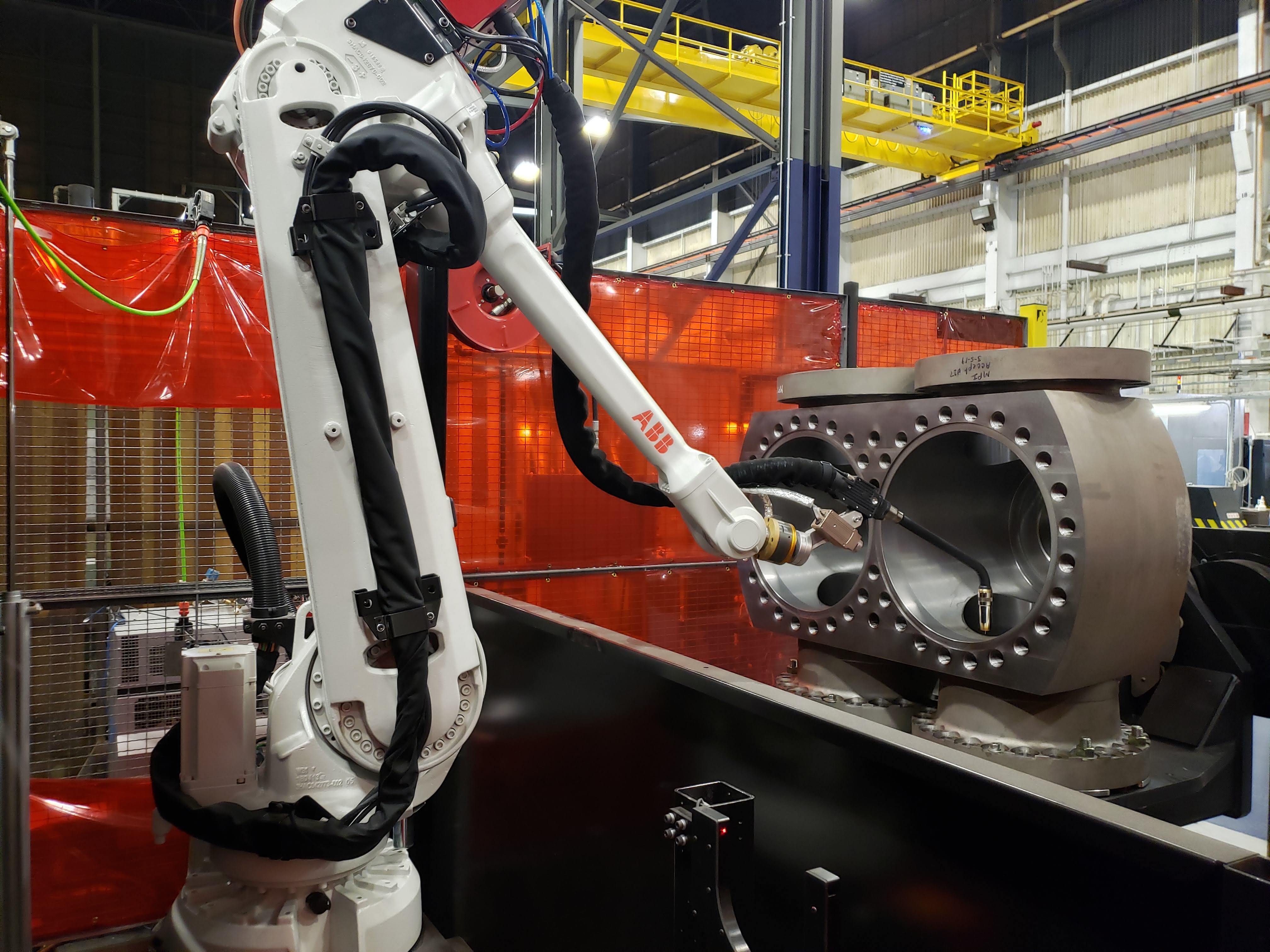 Robotic welding arm inside the body of the Improved Low Loss Launch Valve 