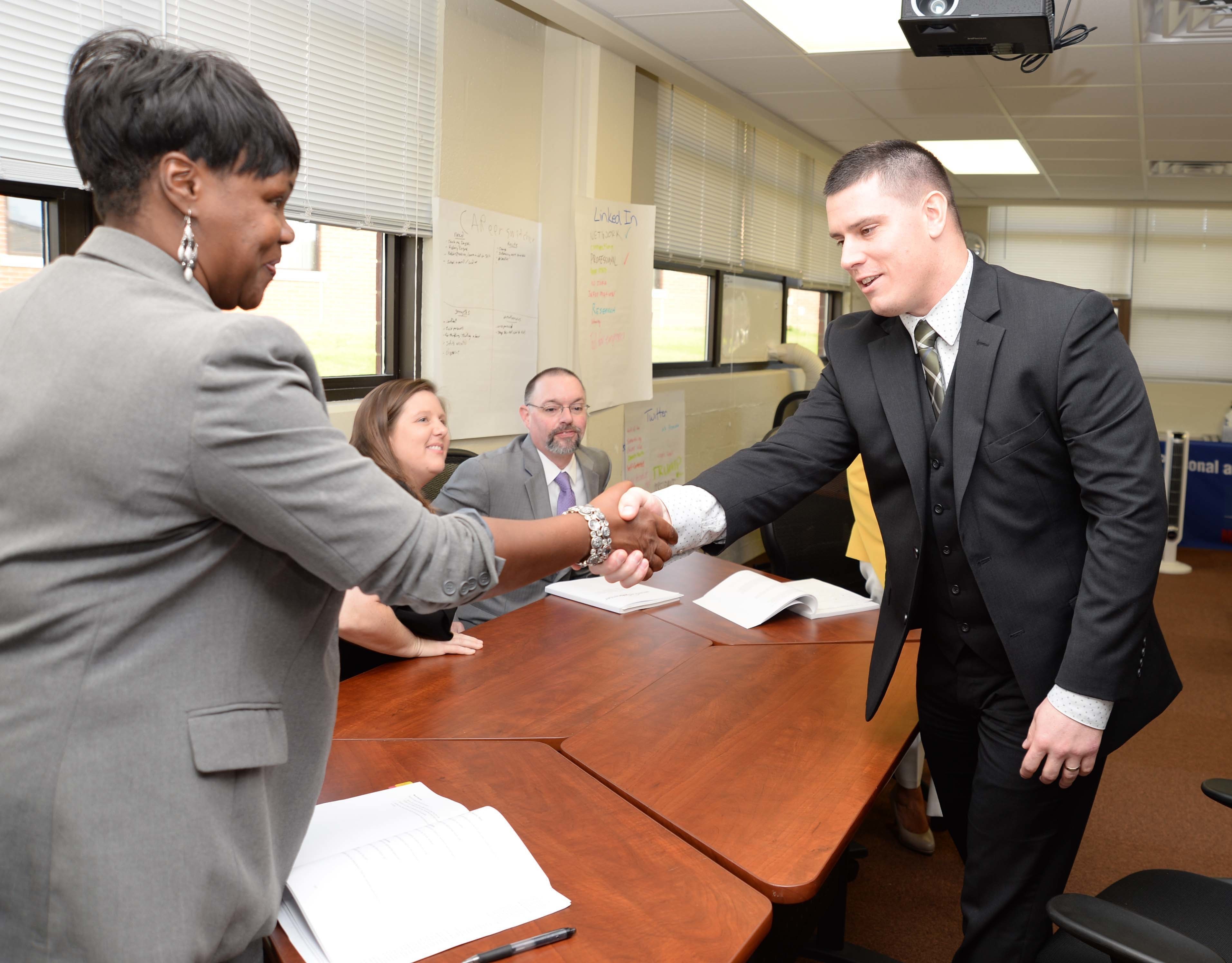 Mock interview participants shake hands