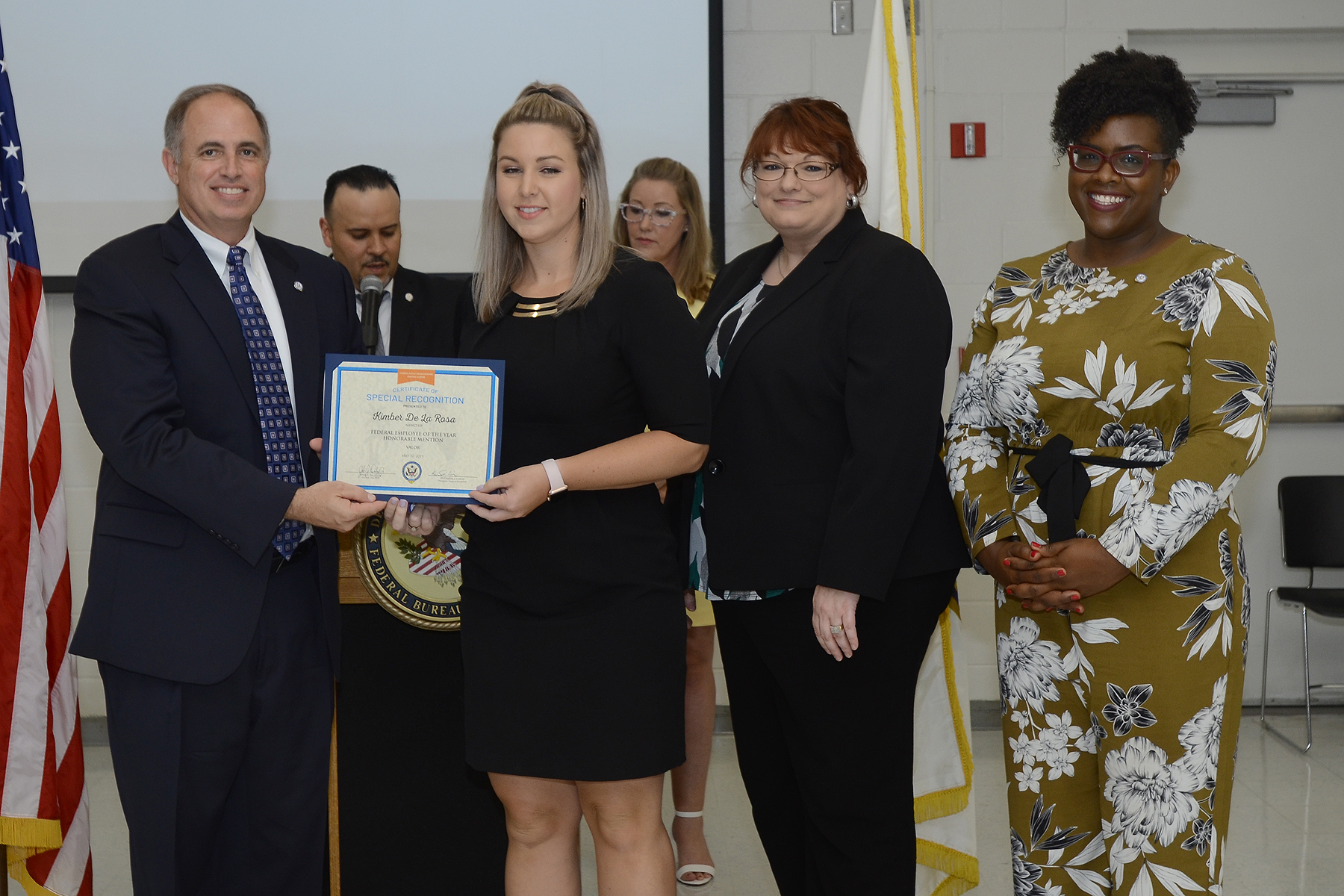 John J. Daly, President of the Central Florida Federal Executive Association presents NAWCTSD Management Analyst, Kimber De La Rosa with the association's Federal Employee of the Year Honorable Mention in the Valor Category. 