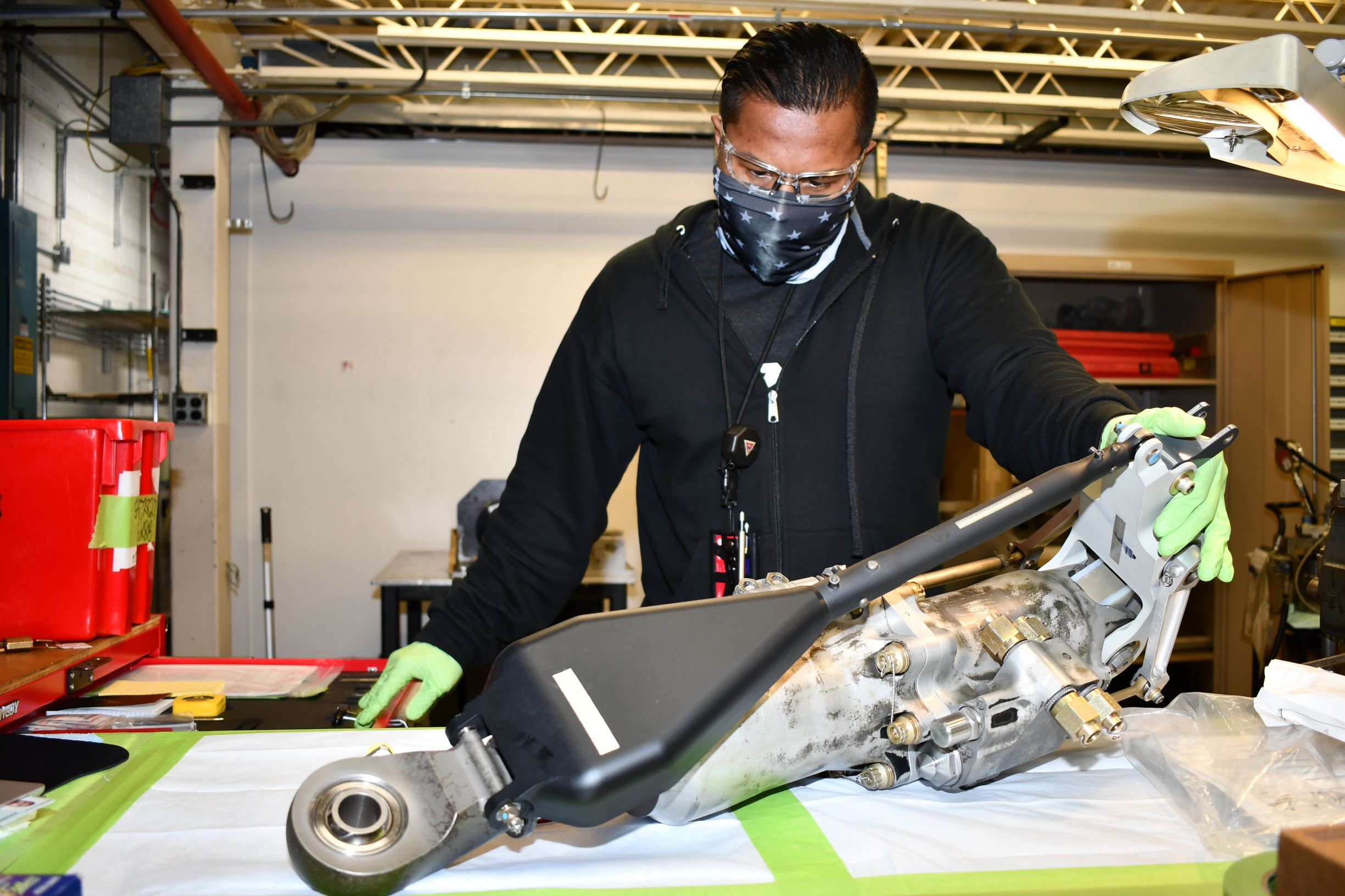 Man assembles H-53 helicopter primary servo cylinder