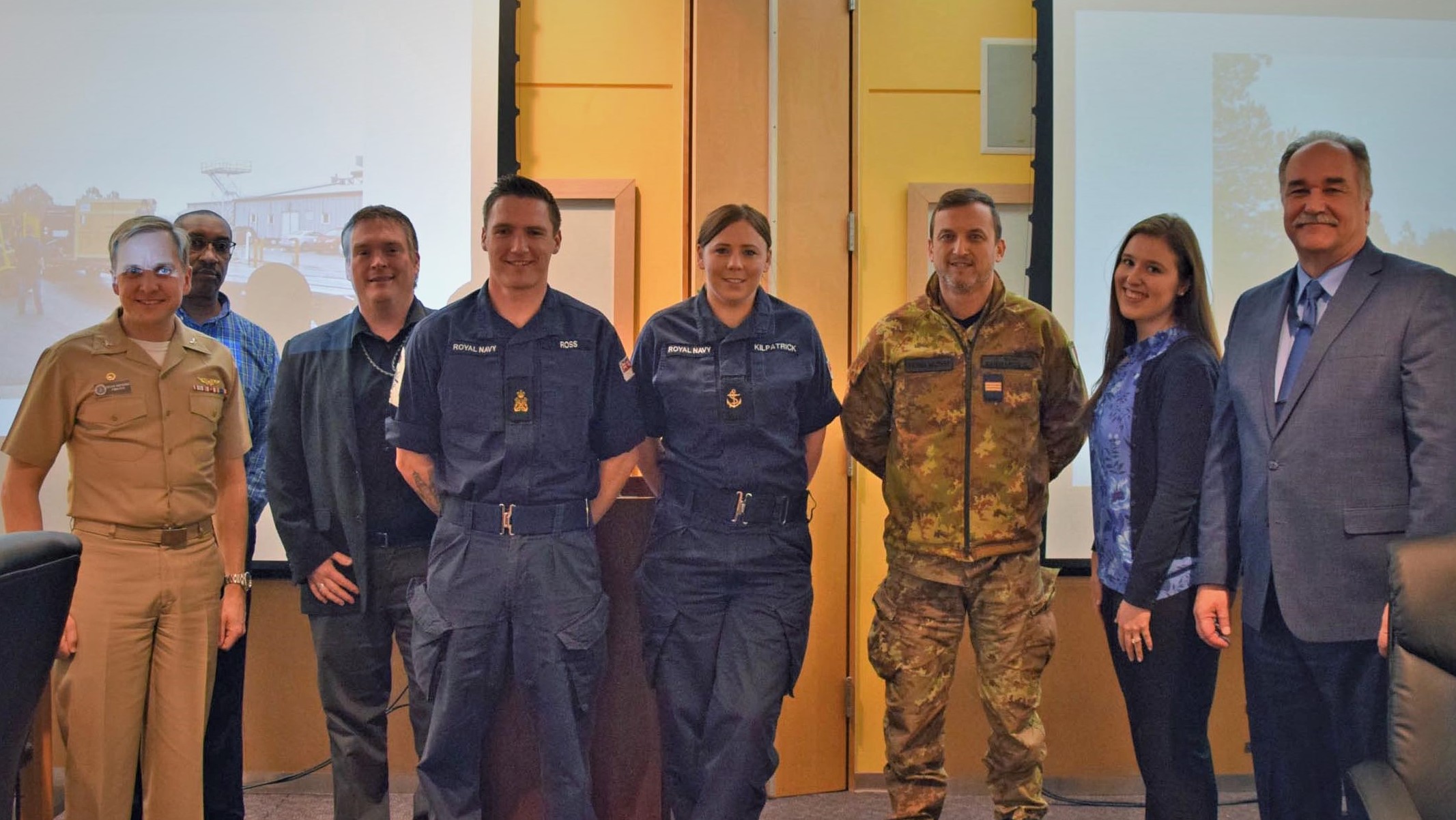 Three international sailors completing NAWCAD WOLF AN/SPN-41B technical training