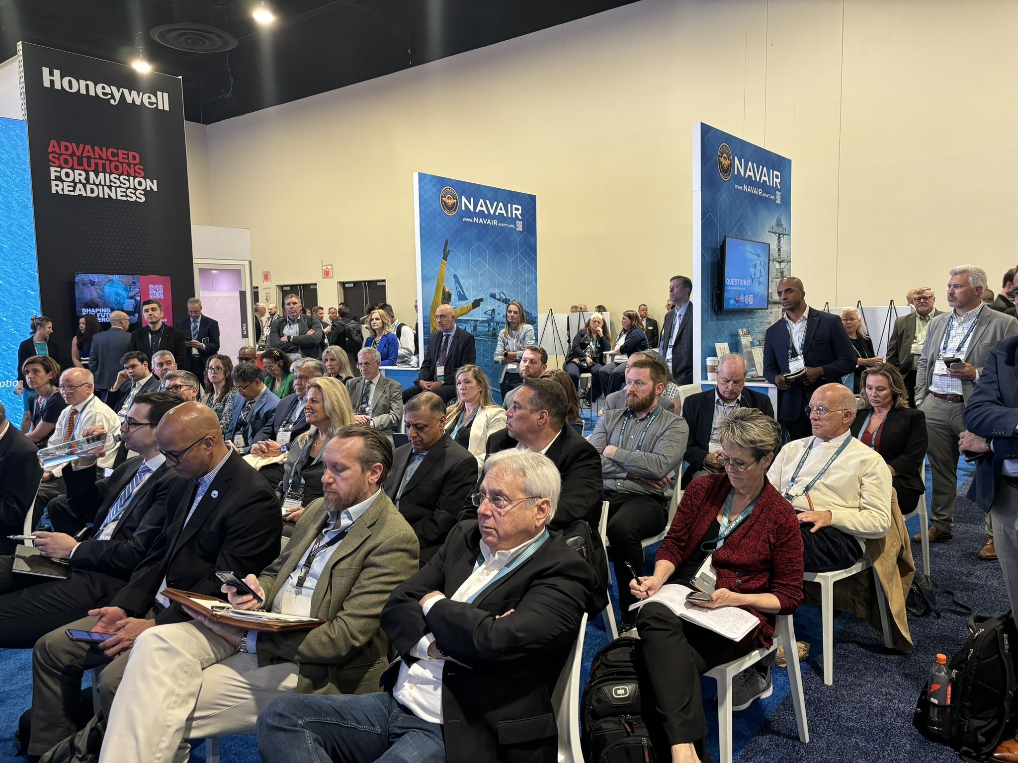 Audience members listen to a presentation given by NAVAIR leadership