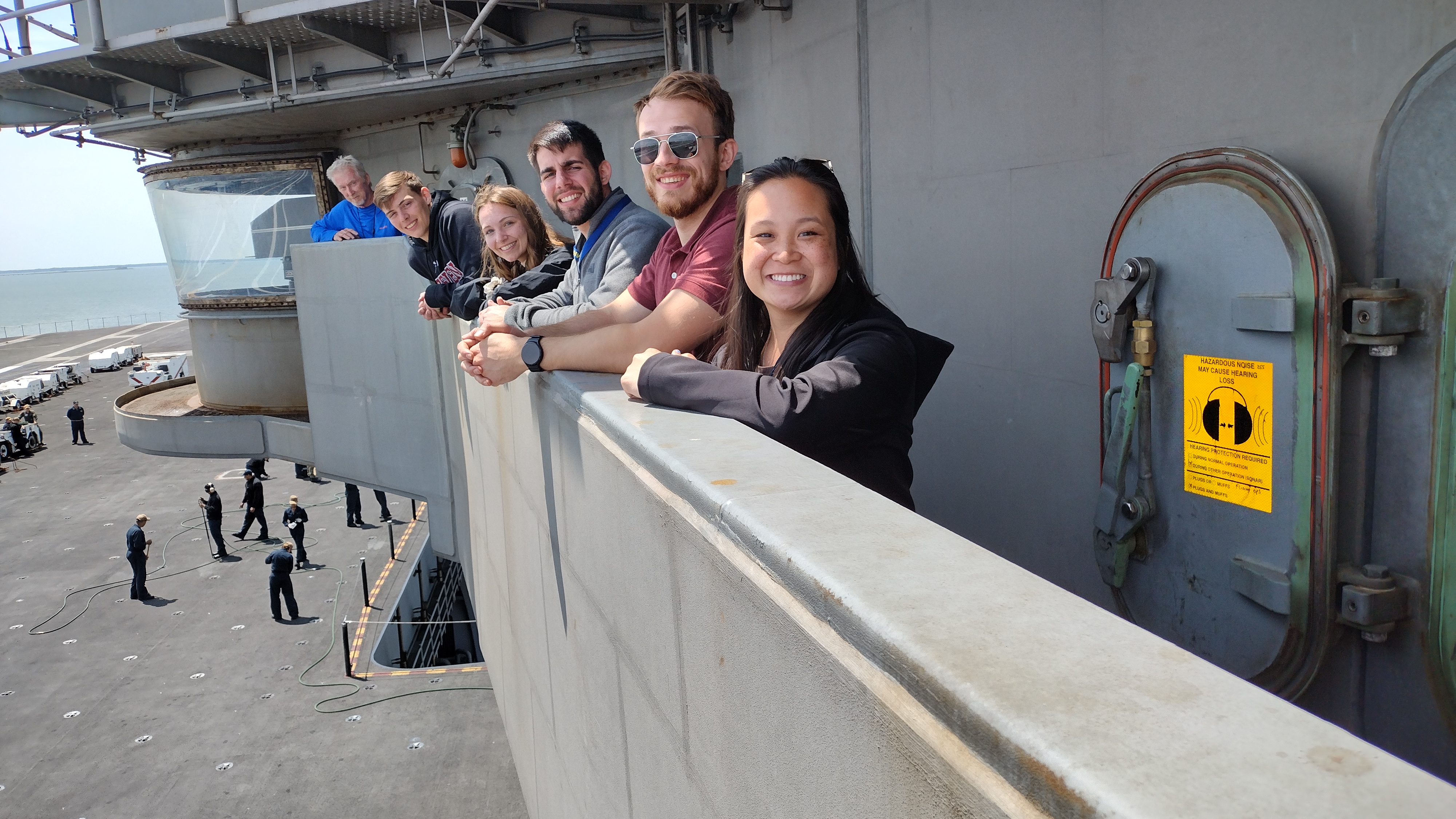 Team members pose on ship trip
