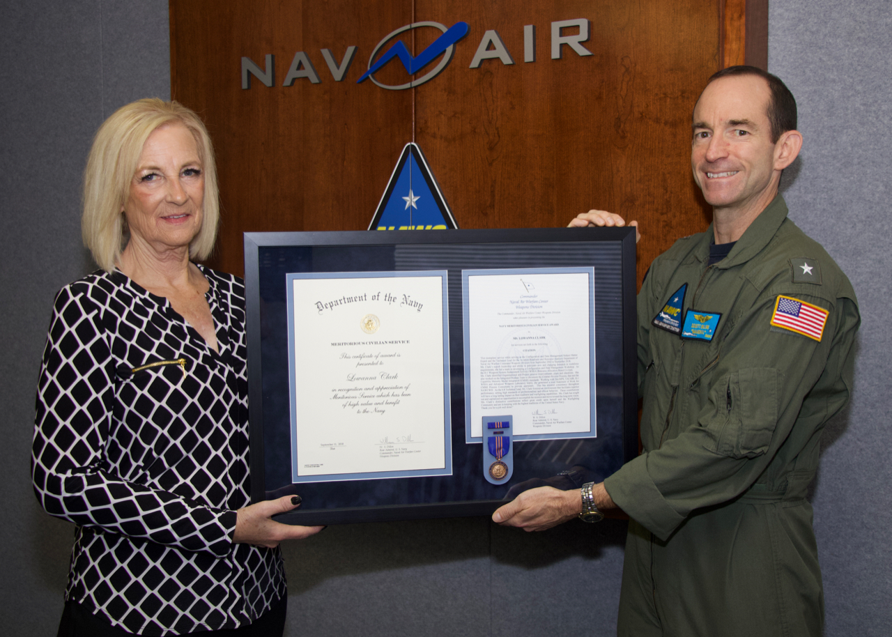 Lea Clark receives a Navy Meritorious Civilian Service Award from Rear Adm. Scott Dillon, Naval Air Warfare Center Weapons Division commander, during a Nov. 9 ceremony at China Lake. (U.S. Navy photo released)