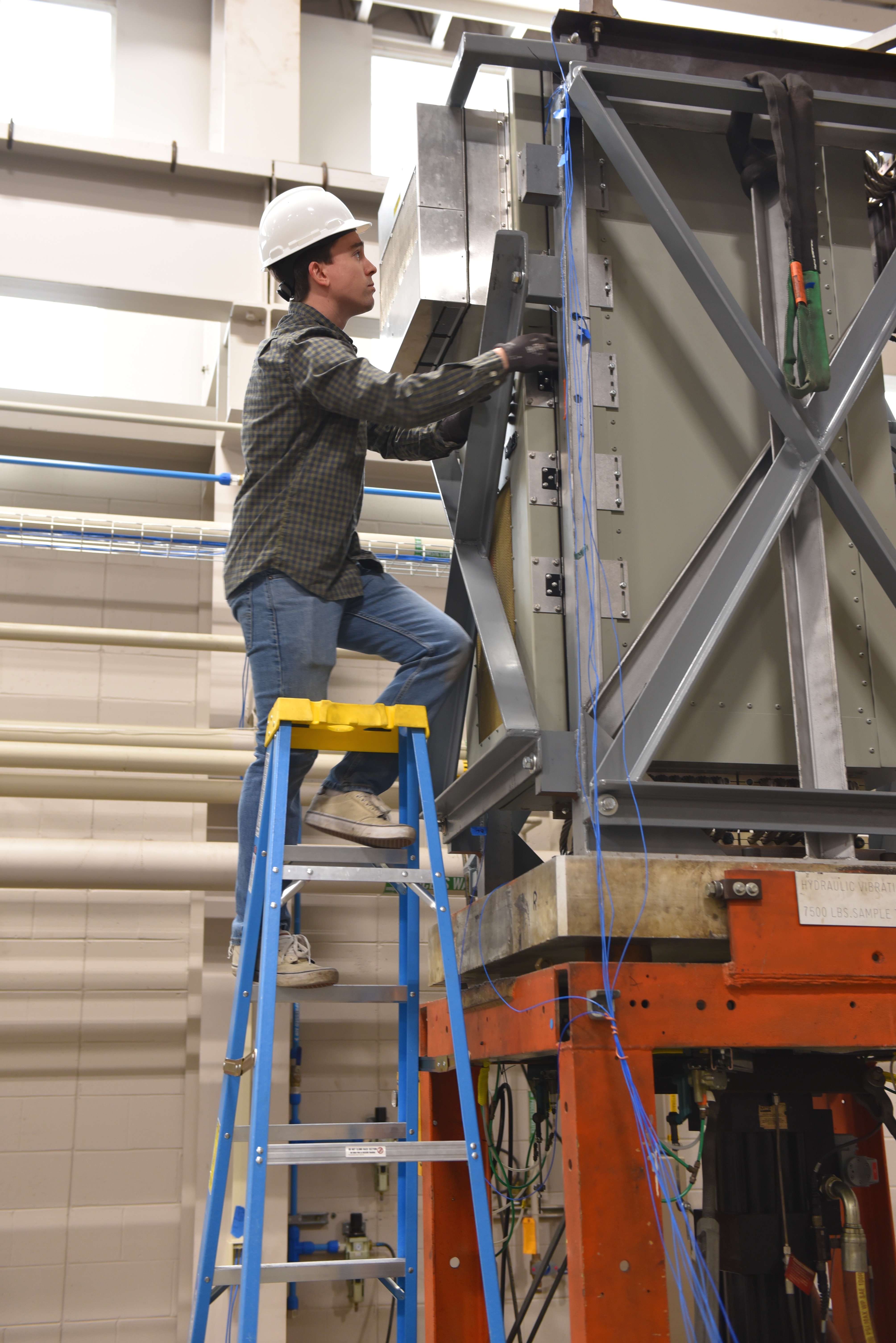 ETL teammate checks a piece of equipment during testing