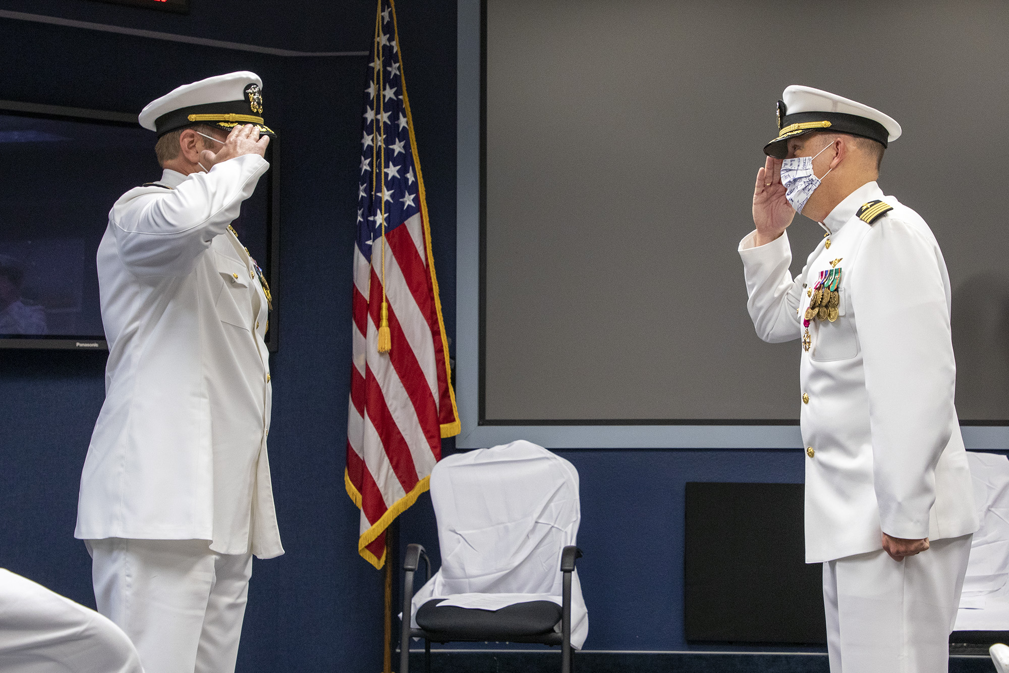 Capt. Ryan Bryla, left, relieves Capt. A.J. McFarland as commodore of Naval Test Wing Pacific during a change of command ceremony June 19 in Point Mugu, California. (U.S. Navy photo by Brian Wulfekotte)
