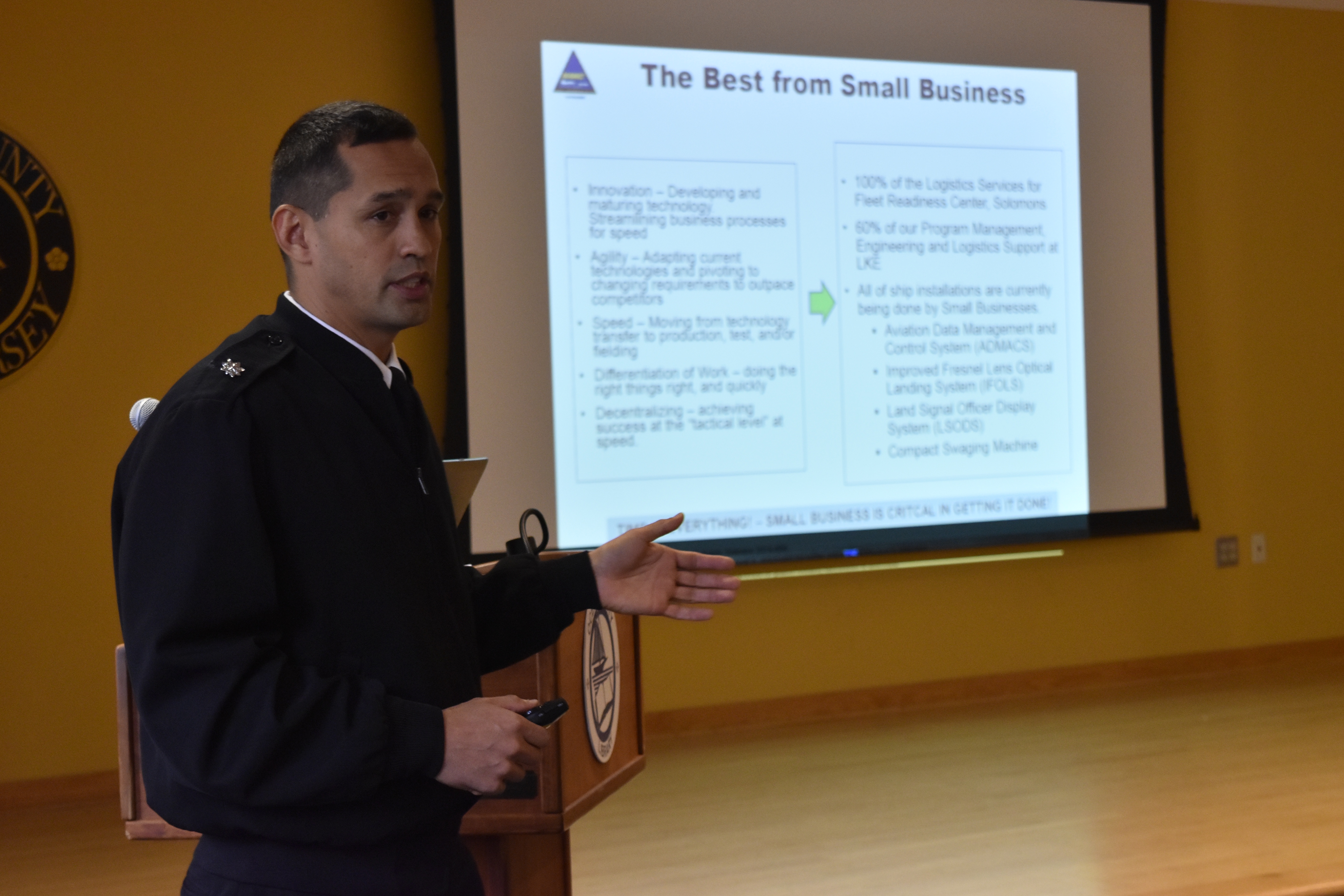 Officer-In-Charge Cmdr. Walter A. Reynolds briefs "The Best from Small Business" slide