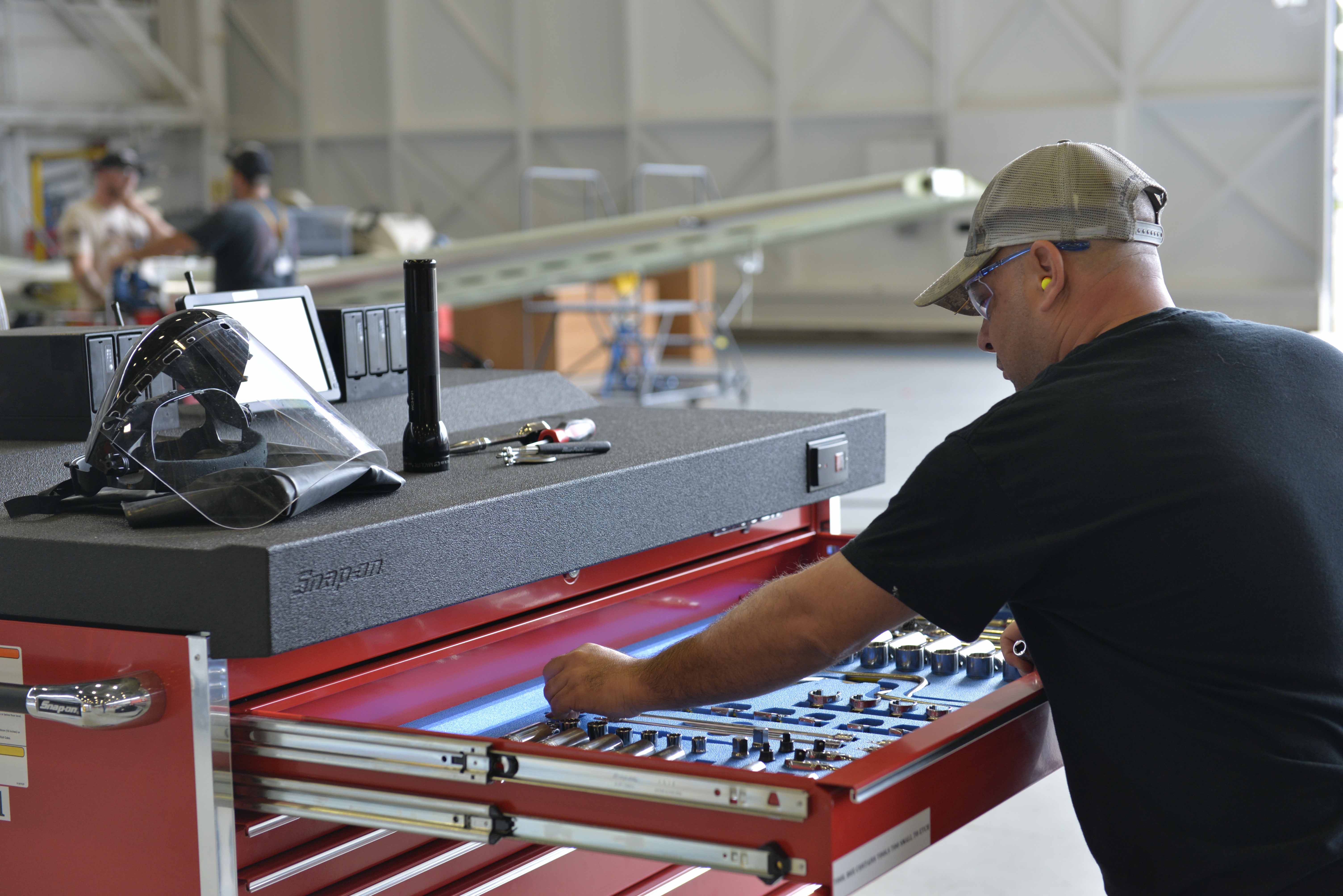 Fleet Readiness Center Southeast aircraft mechanic Tom Fotos pulls a tool out of the new electronic toolboxes.