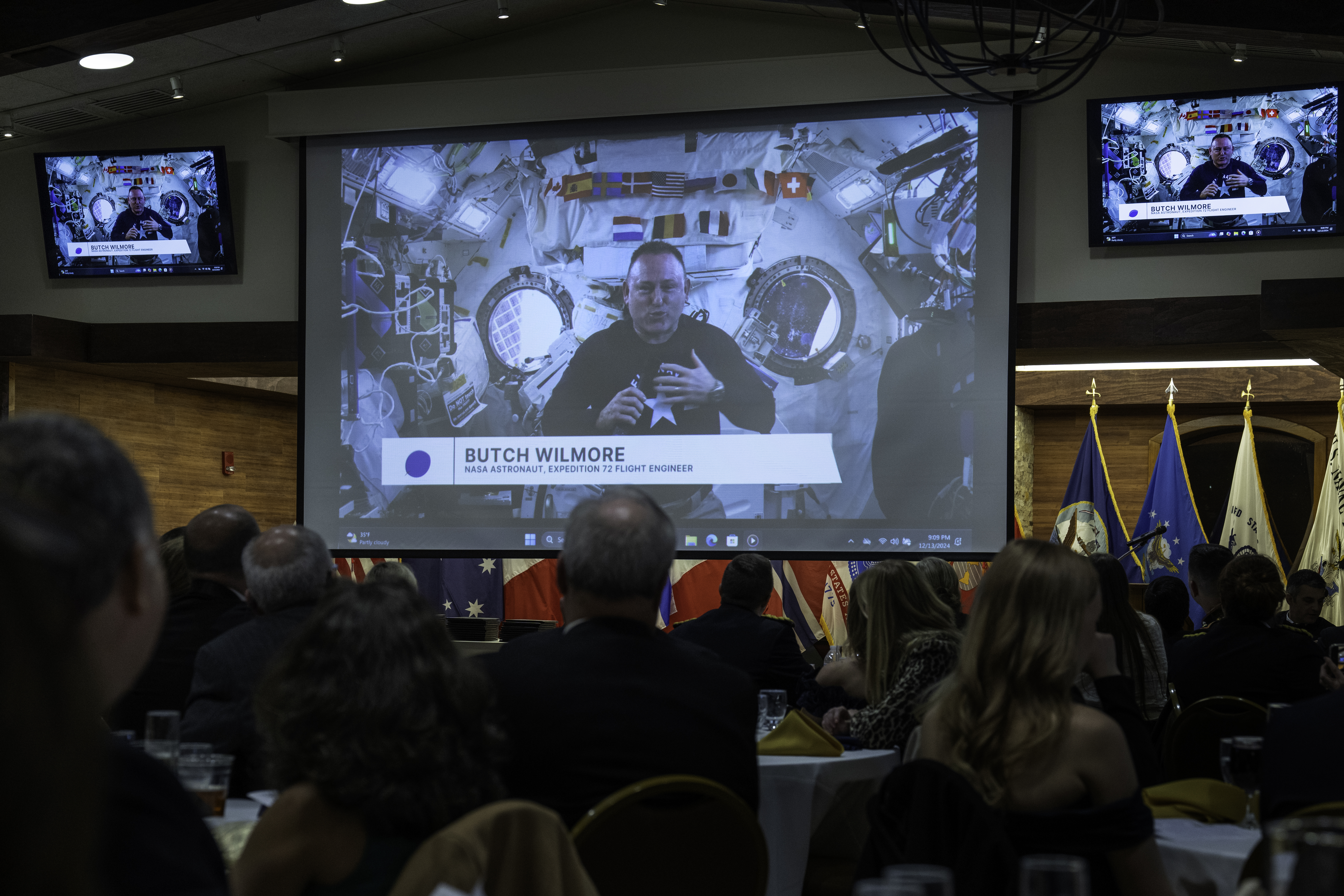 Astronaut Barry Wilmore floats while he delivers remarks onboard the International Space Station.