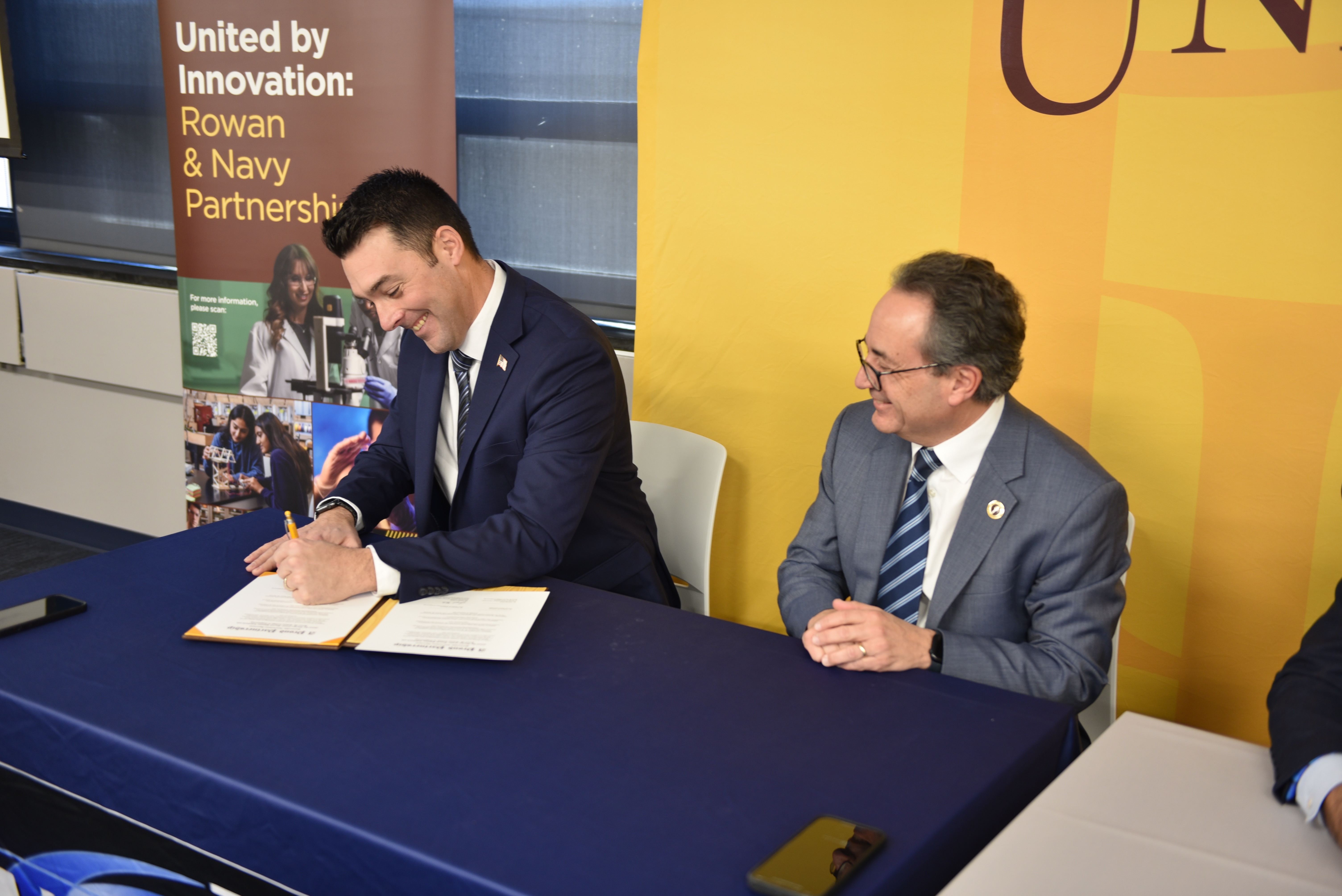 Joe Hader from NAWCAD Lakehurst signs partnership agreement with Rowan University