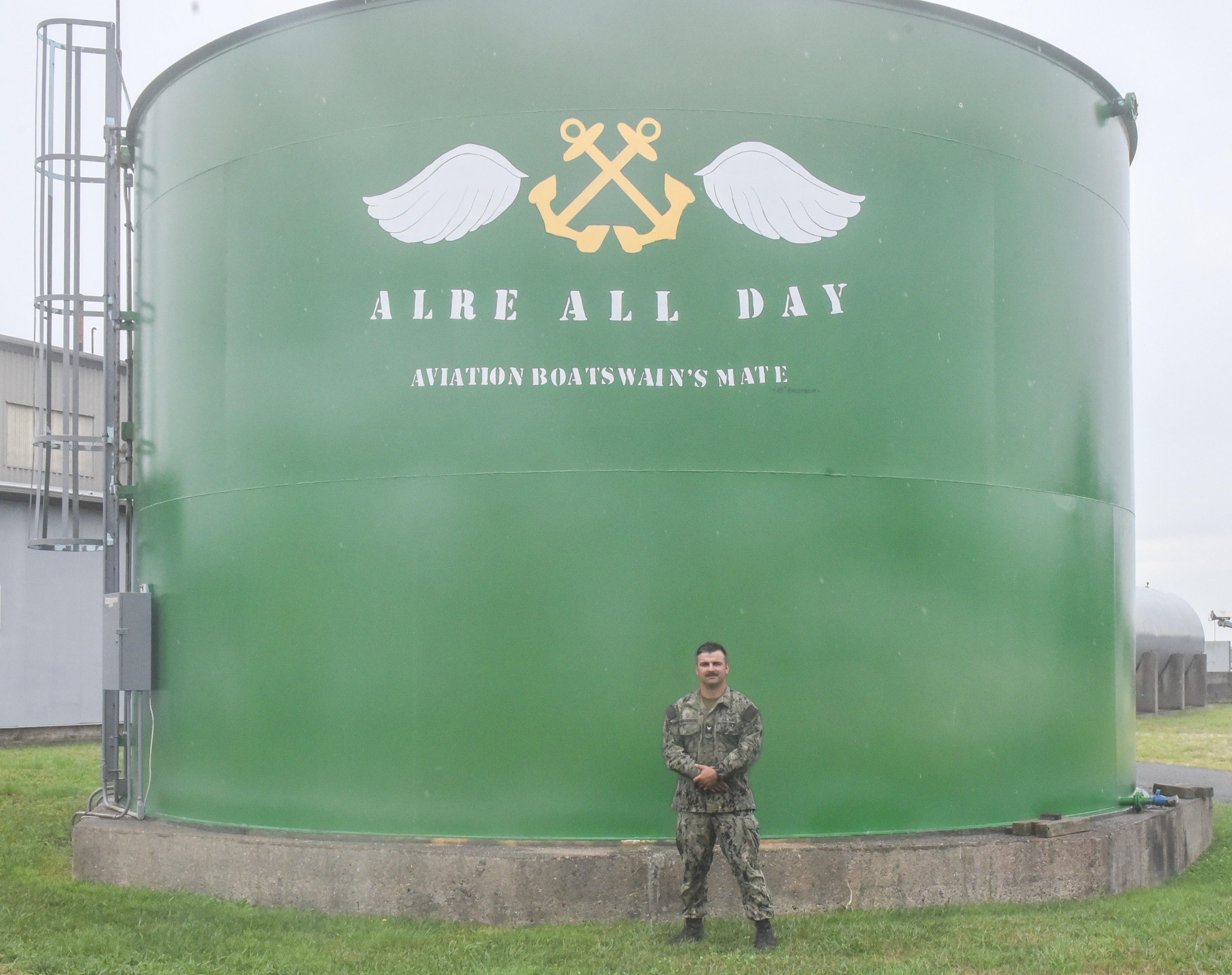 Aviation Boatswain's Mate Second Class Philip Ringgenberg stands by the water tower at Naval Air Warfare Center Aircraft Division Lakehurst