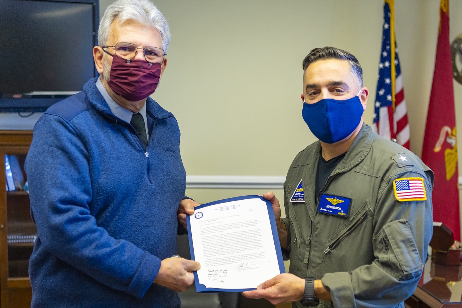 Rear Adm. John S. Lemmon, right, presents Tony Spadarella with the 2021 NAWCAD Patuxent River Mentor of the Year Award during a ceremony at the VX-20 hangar on Feb. 8.