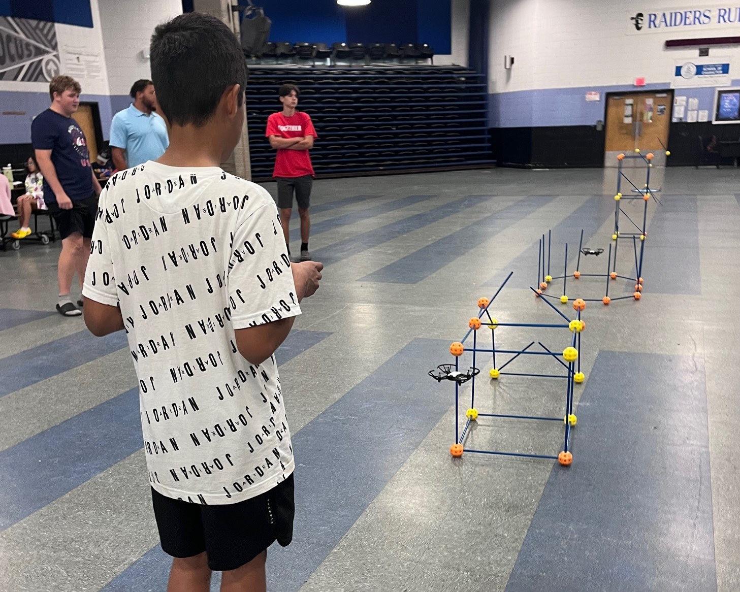 Child flying a drone at camp