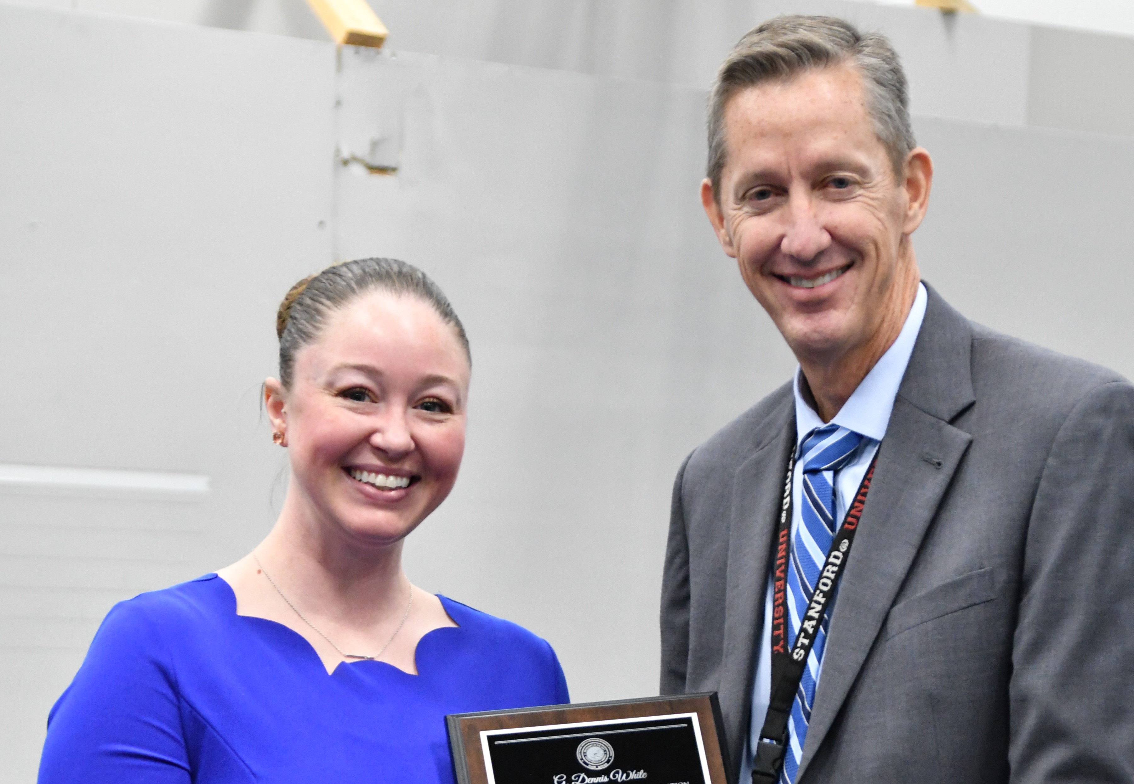 man and woman smiling holding an award