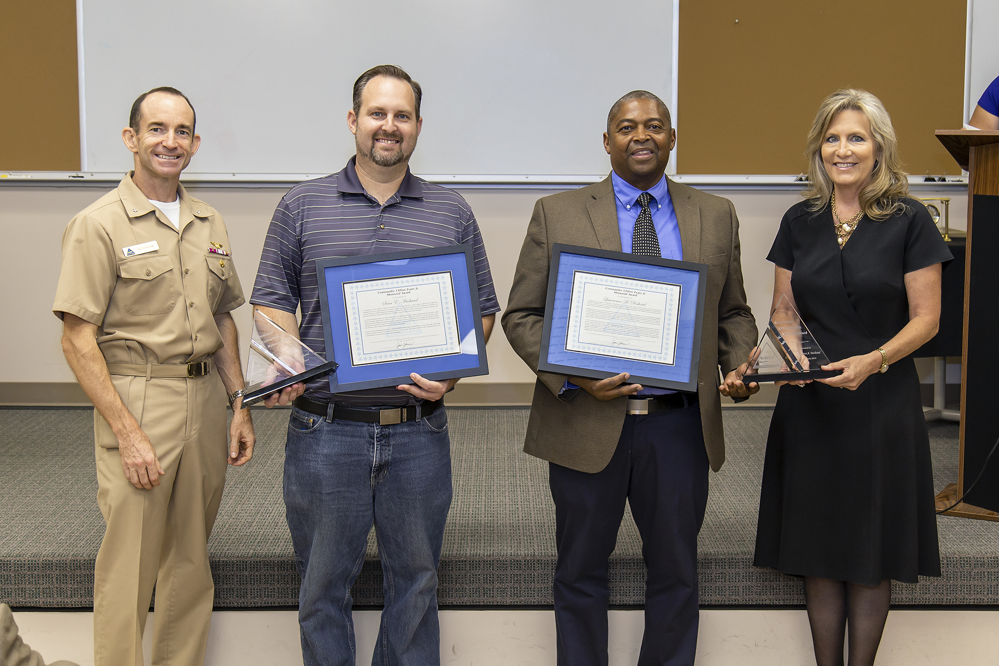 Rear Adm. Scott Dillon, left, NAWCWD commander, and Joan Johnson, right, NAWCWD executive director, pose with CDR Clifton Evans Jr. Memorial Award winners Sean Husband and Lawrence Deshotel during the Honorary Awards Ceremony in Point Mugu, California, on June 27. Award recipient Mark Roth was unable to attend. (U.S. Navy photo by Rob Grabendike)