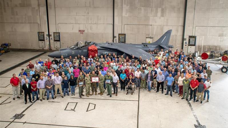 large group of people in front of AV-8B Harrier