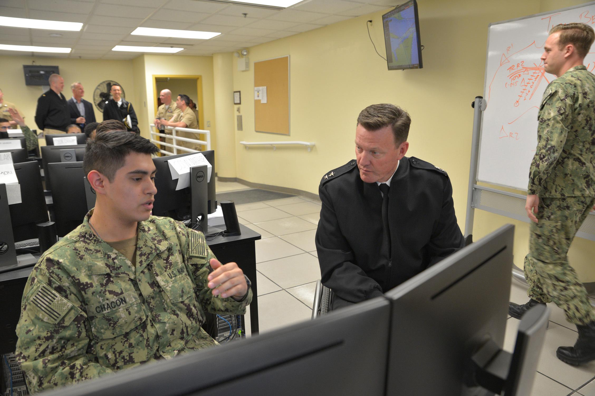GREAT LAKES, Ill (April 26, 2019) Rear Adm. Kyle Cozad, commander of Naval Education and Training Command, visits with students at Center for Surface Combat Systems Unit Great Lakes Operations Specialist "A" School in the VMS lab, April 26, 2019. (U.S. Navy photo by Brian Walsh/Released)