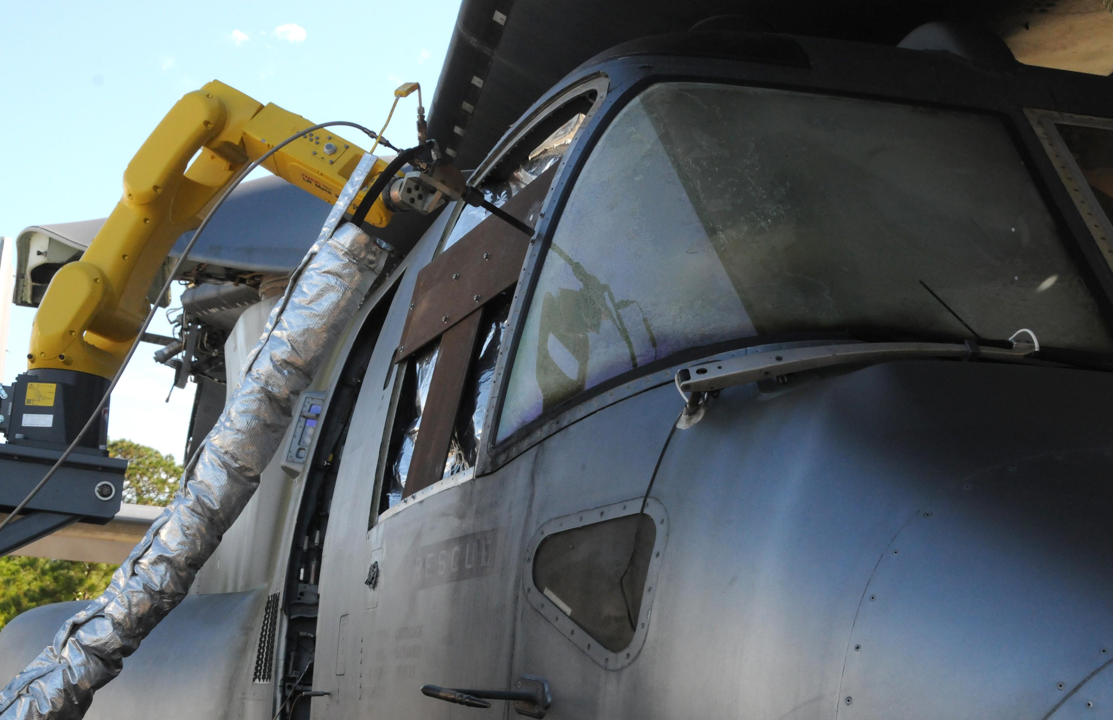 A mobile, autonomous robot deposits a cold spray coating on a V-22 aircraft