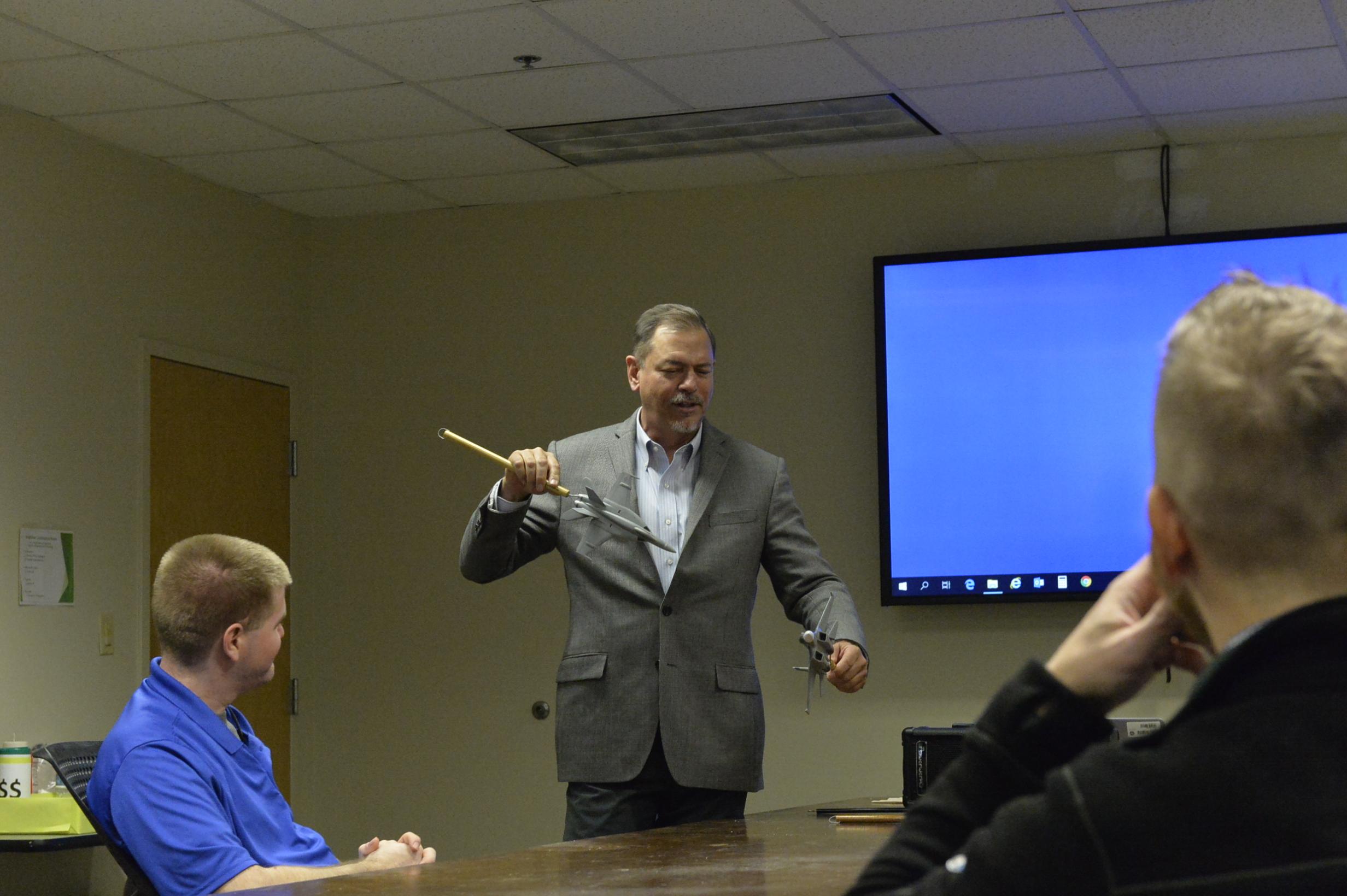 Ian Anderson, director of the Tactical Engineer Development Program at Naval Air Warfare Center Weapons Division, discusses air combat tactics with class participants at Naval Air Station Patuxent River as a way to help them better understand the operational needs of warfighters.