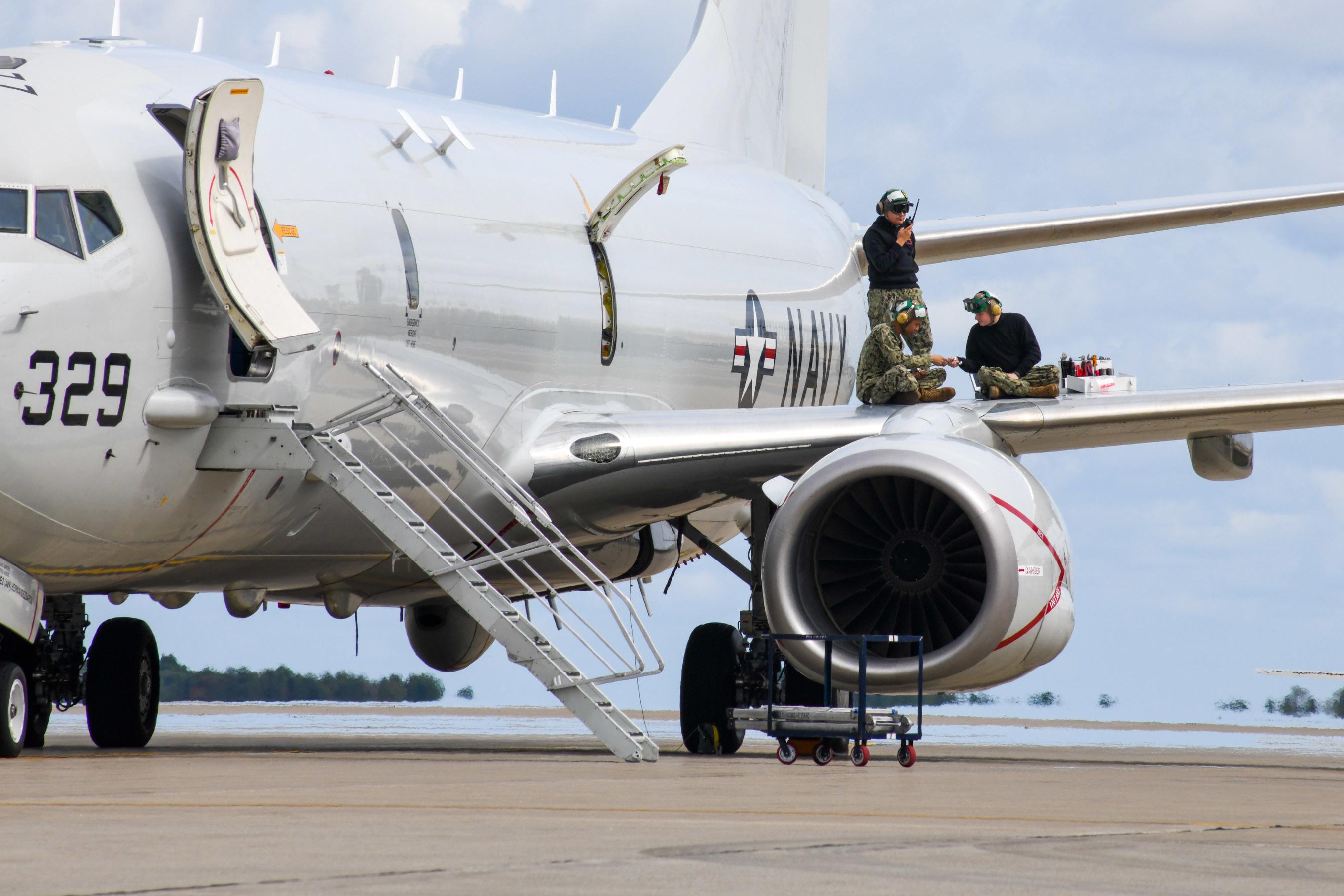 Sailors assigned to Patrol Squadron 1 conduct engine maintenance on a P-8A Poseidon. 