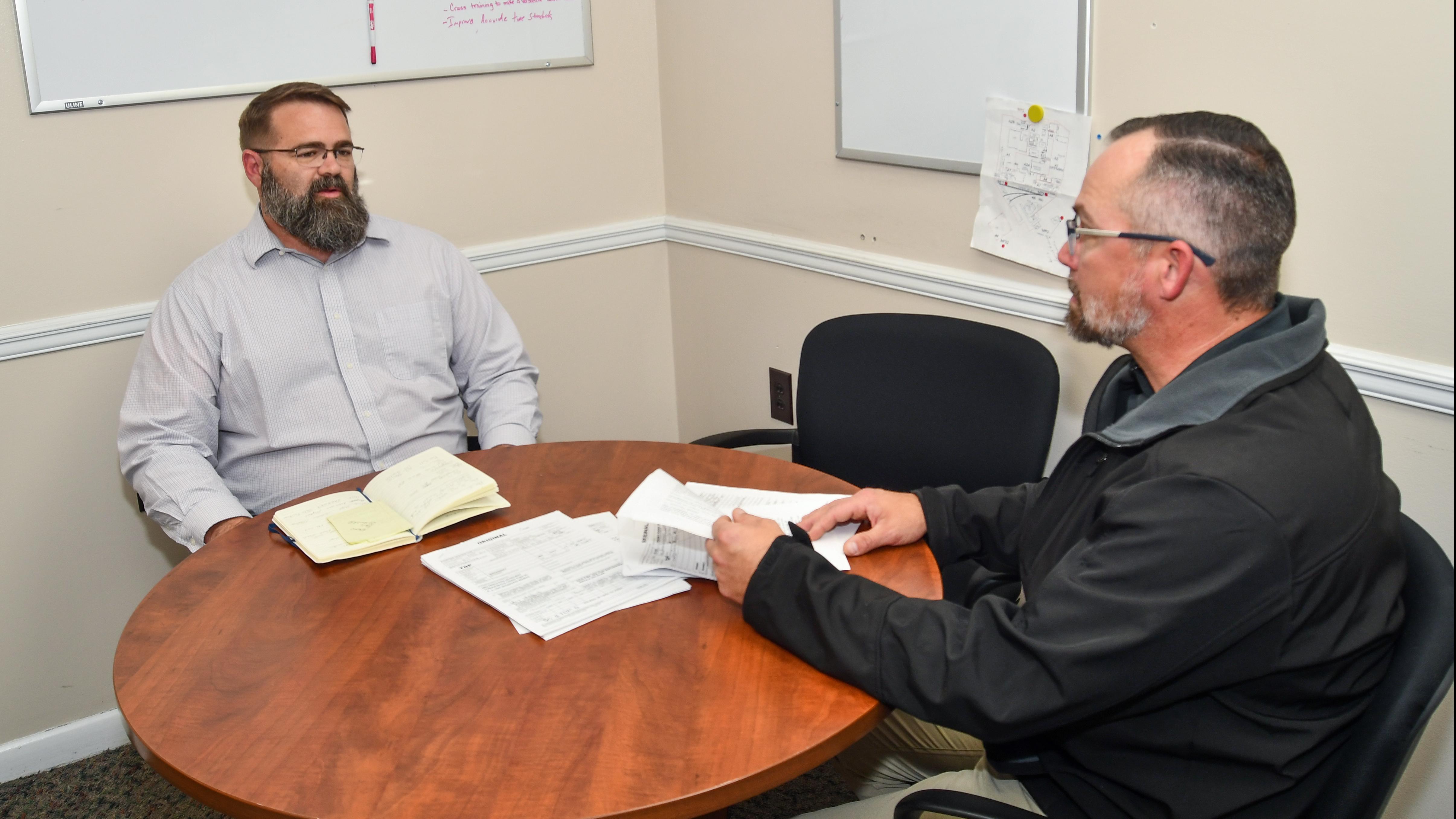 Two men sitting at a round table 