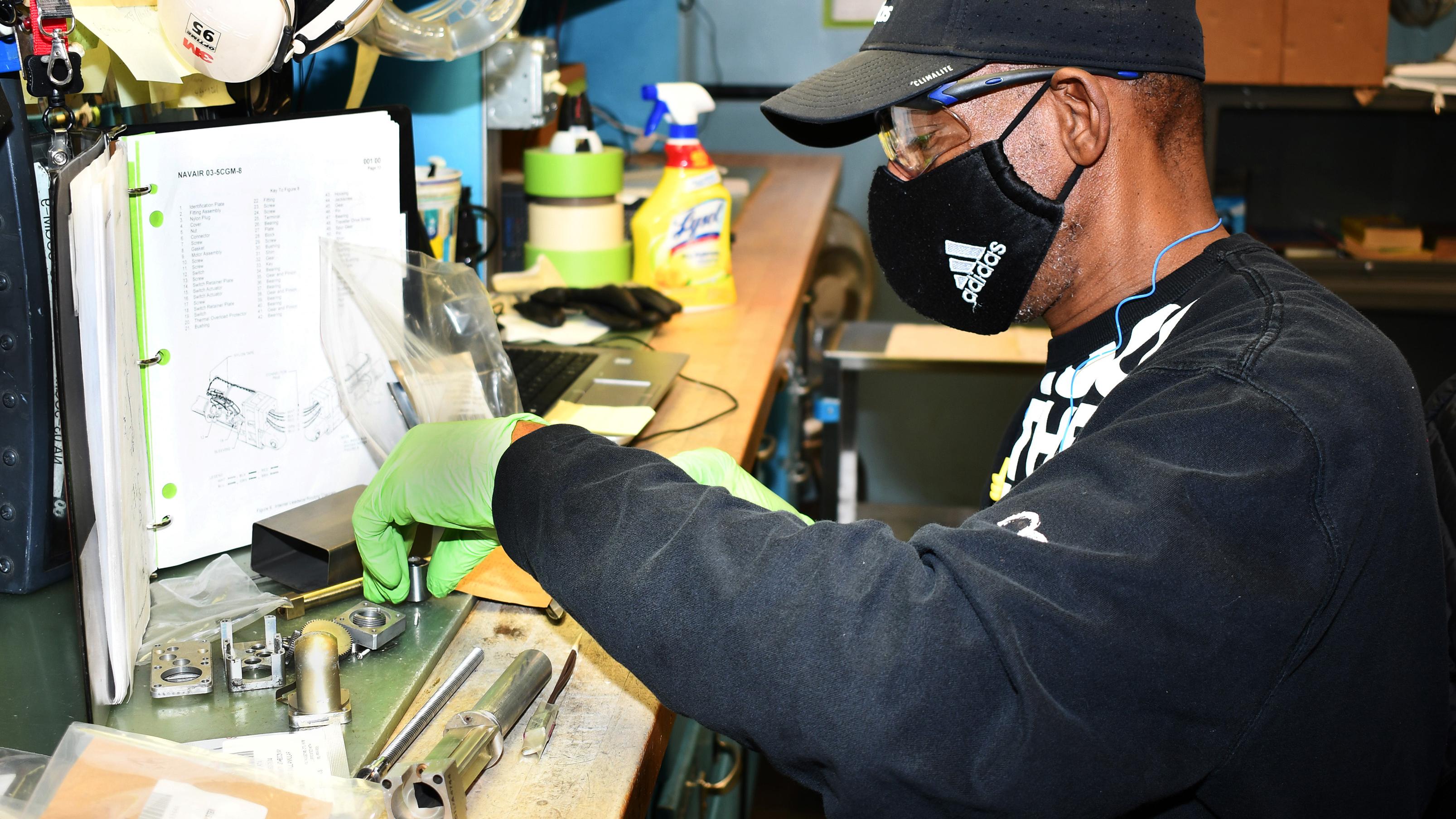 Man sorts parts on workbench