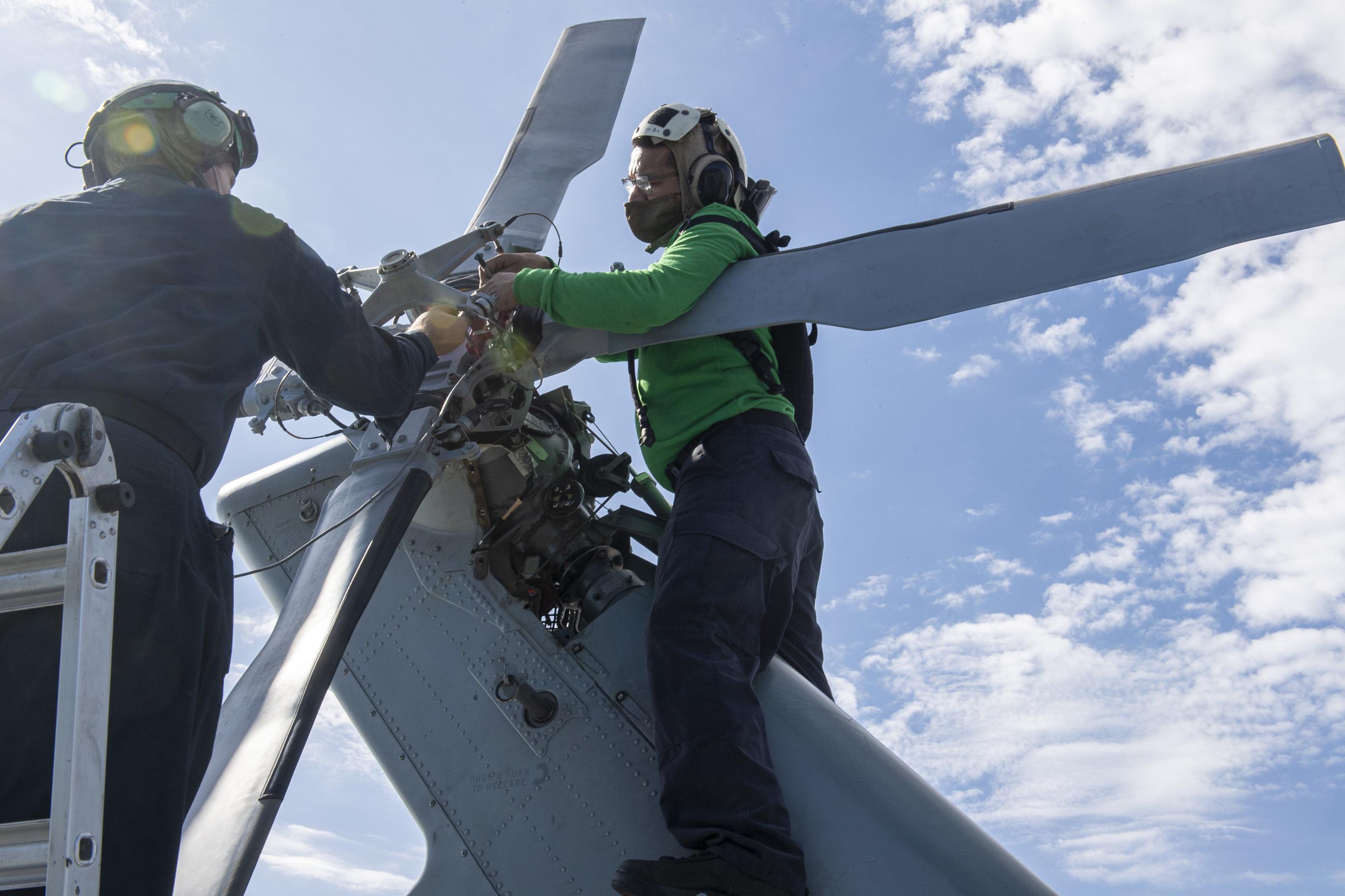 Maintenance on the tail rotor of a MH-60S Seahawk helicopter