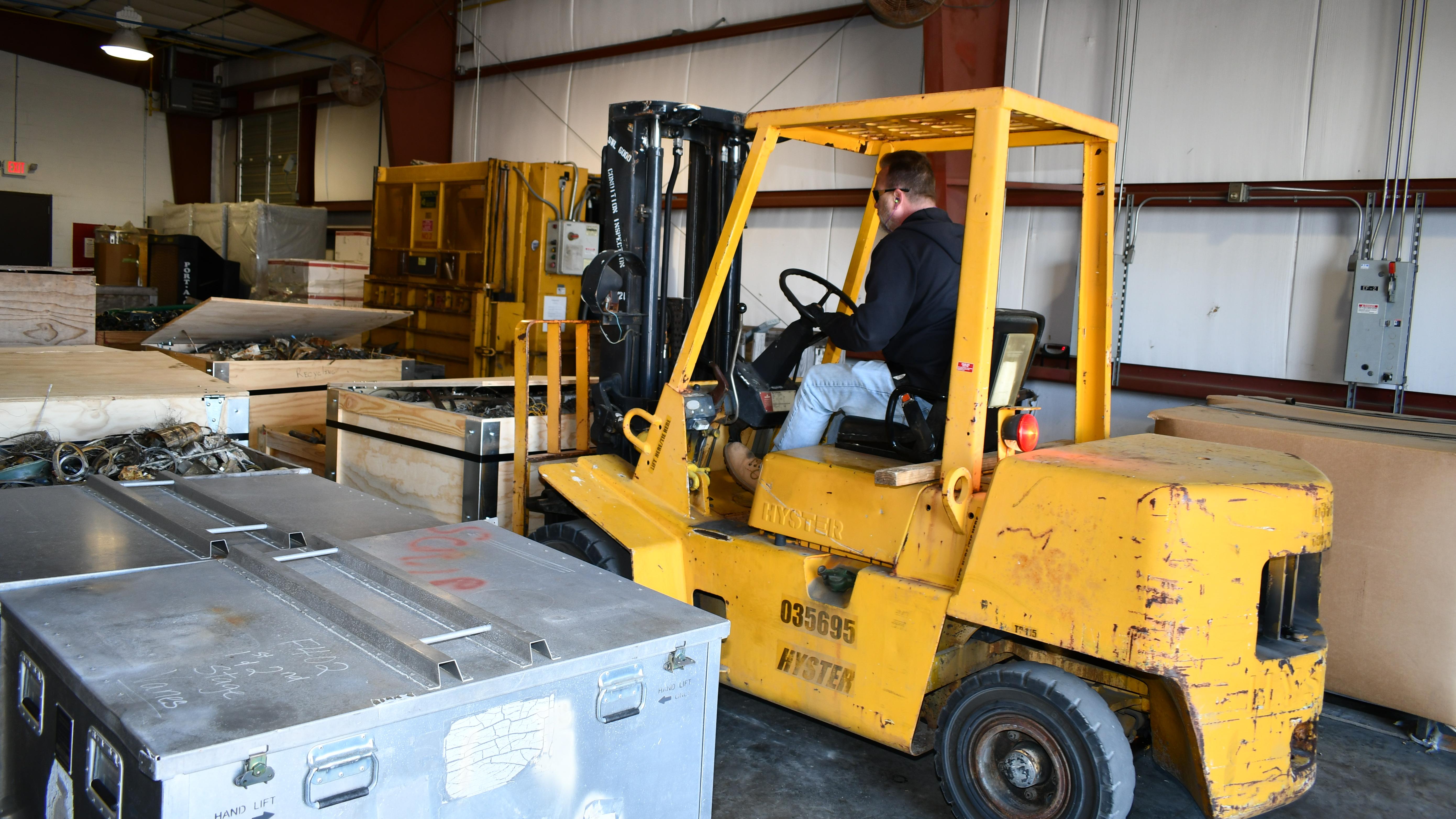 Forklift removes parts from warehouse