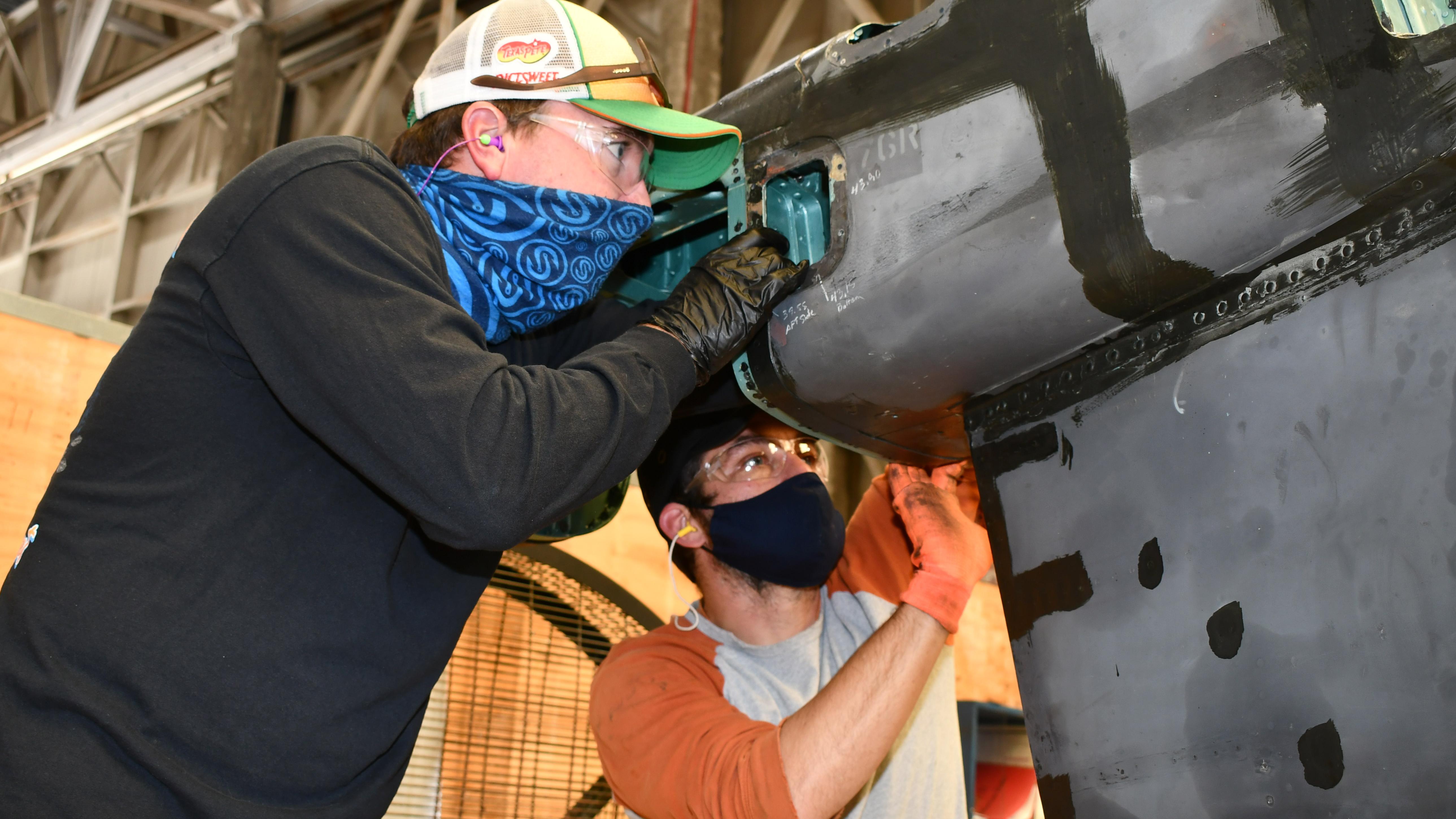 Artisans replace panels on Harrier