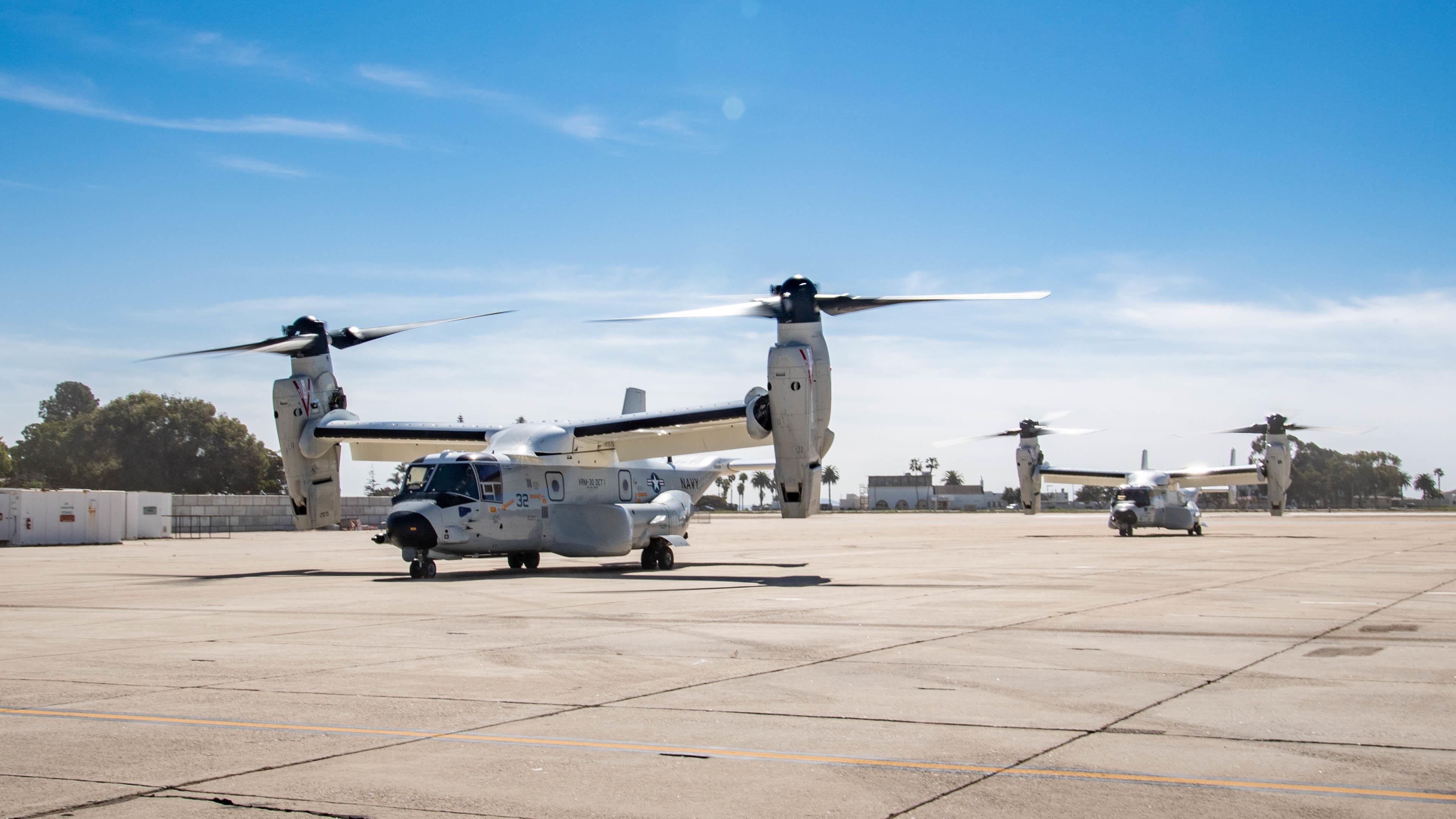 CMV-22B Ospreys, attached to Fleet Logistics Multi-Mission Squadron (VRM) 30, taxi on an airfield runway on Naval Air Station North Island, California.