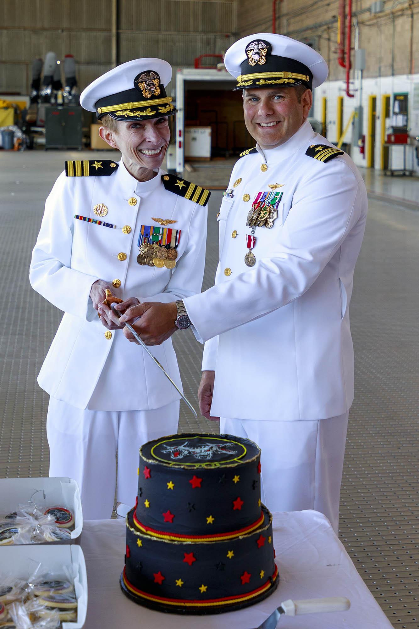 Cmdr. Colette Lazenka and Cmdr. Jason Saglimbene pose for a photo after a May 12 change of command ceremony in which Lazenka relieved Saglimbene of command of Air Test and Evaluation Squadron (VX) 30 in Point Mugu, California. (U.S. Navy photo by Rob Grabendike)