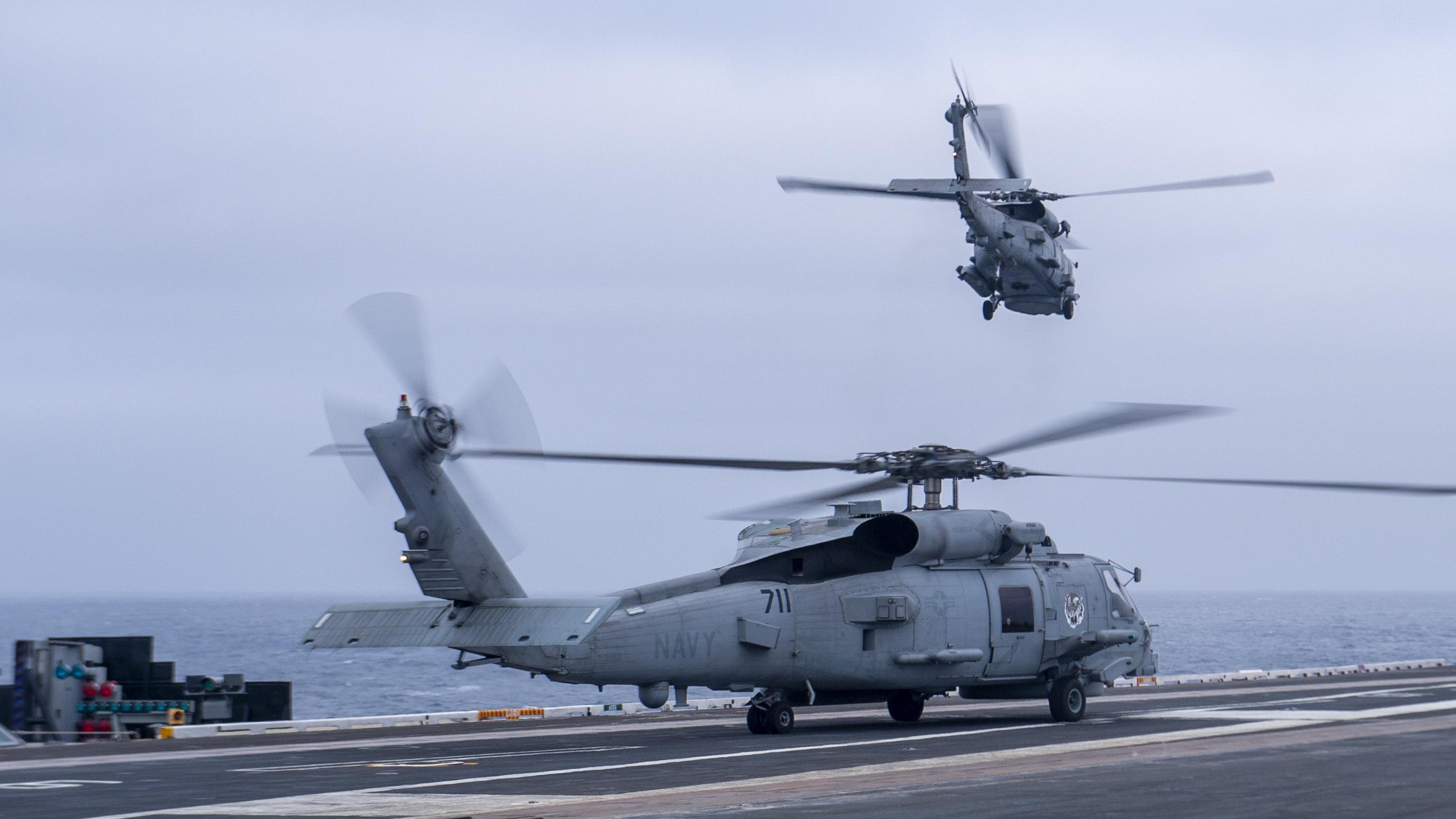 MH-60R on runway and taking off from USS Nimitz May 2022