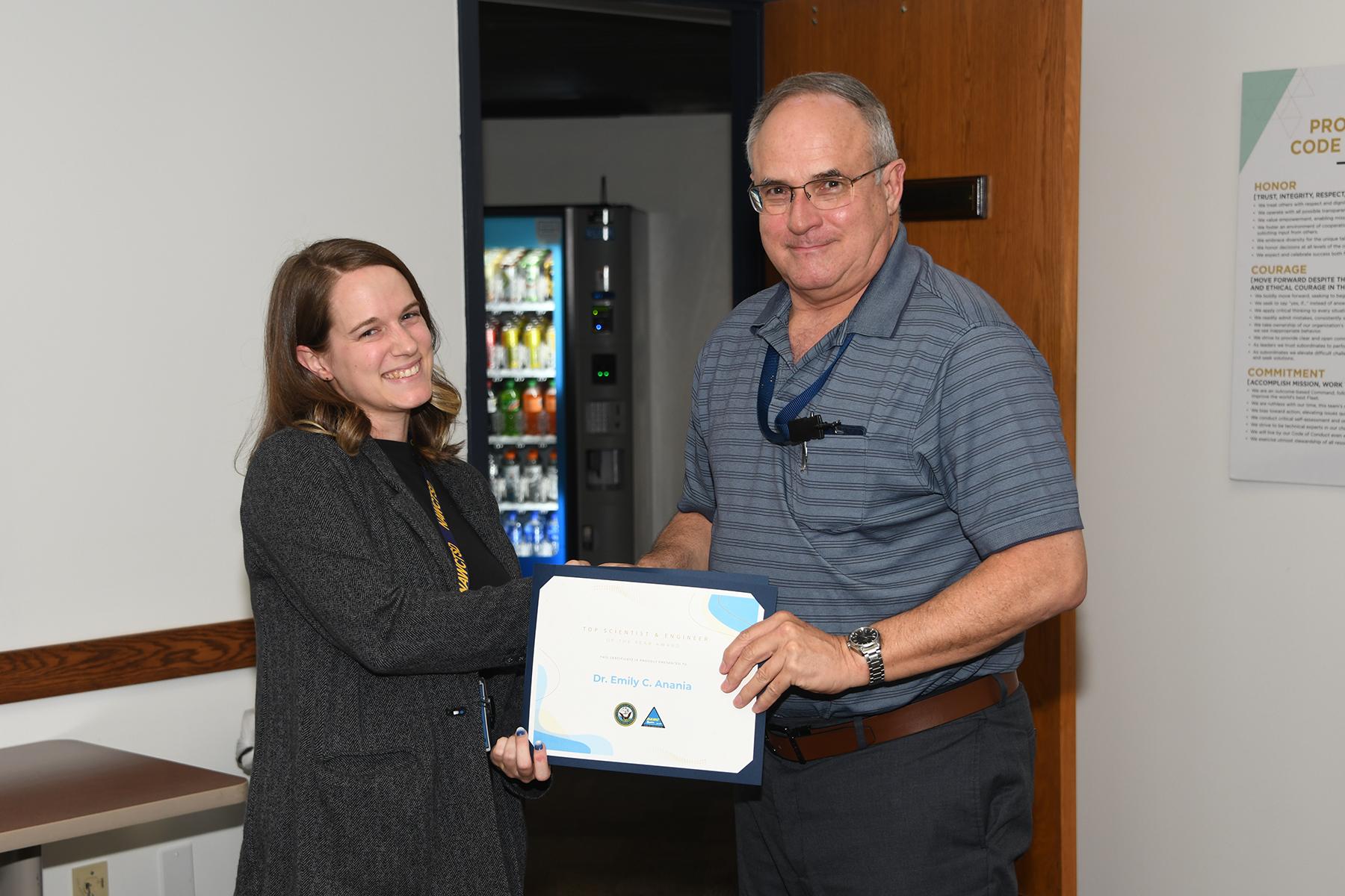 Dr. Emily Anania accepts certificate from Mike Merritt. 