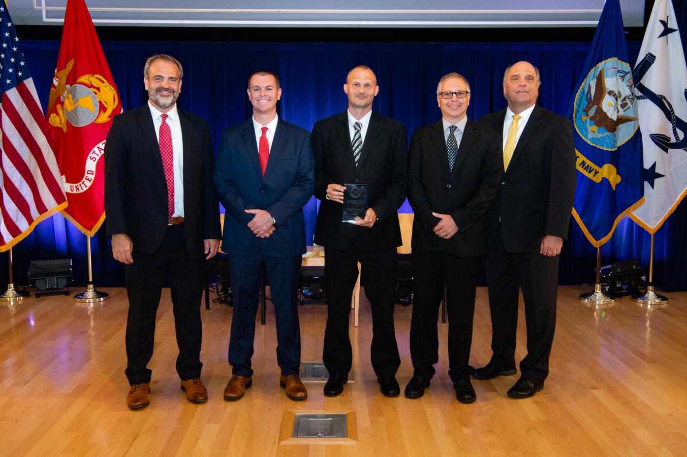 Three FRCE test equipment engineers accept a  2022 Dr. Delores M. Etter Top Scientists and Engineers of the Year award from Assistant Secretary of the Navy for Research, Development and Acquisition leadership.