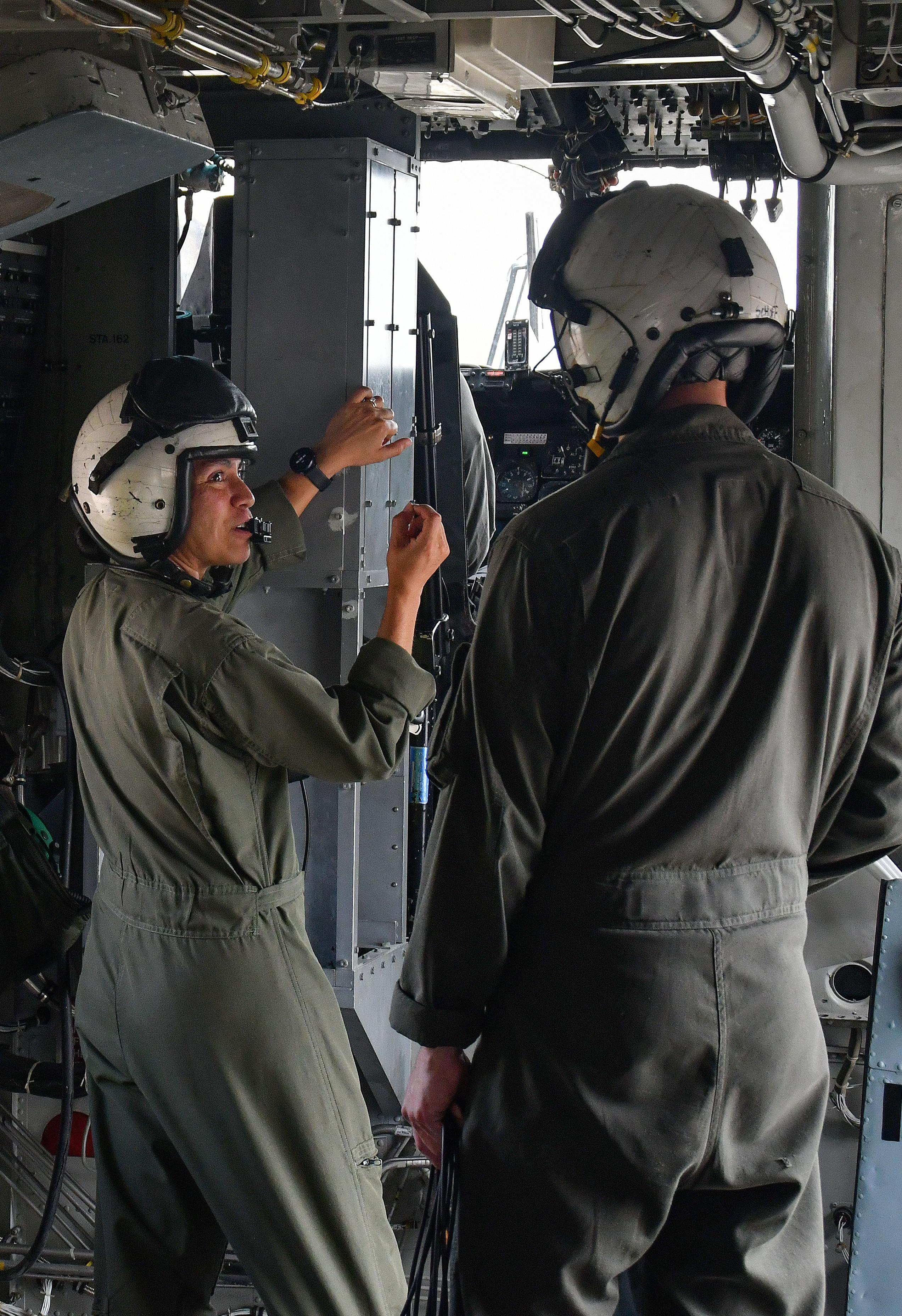 Maj. Brittany Fayos, left, Military Aircraft Production Deputy Director and CH/MH-53 pilot at Fleet Readiness Center East (FRCE), talks with a crew chief prior to conducting a functional check flight inspection of a CH-53 Sea Stallion helicopter. 